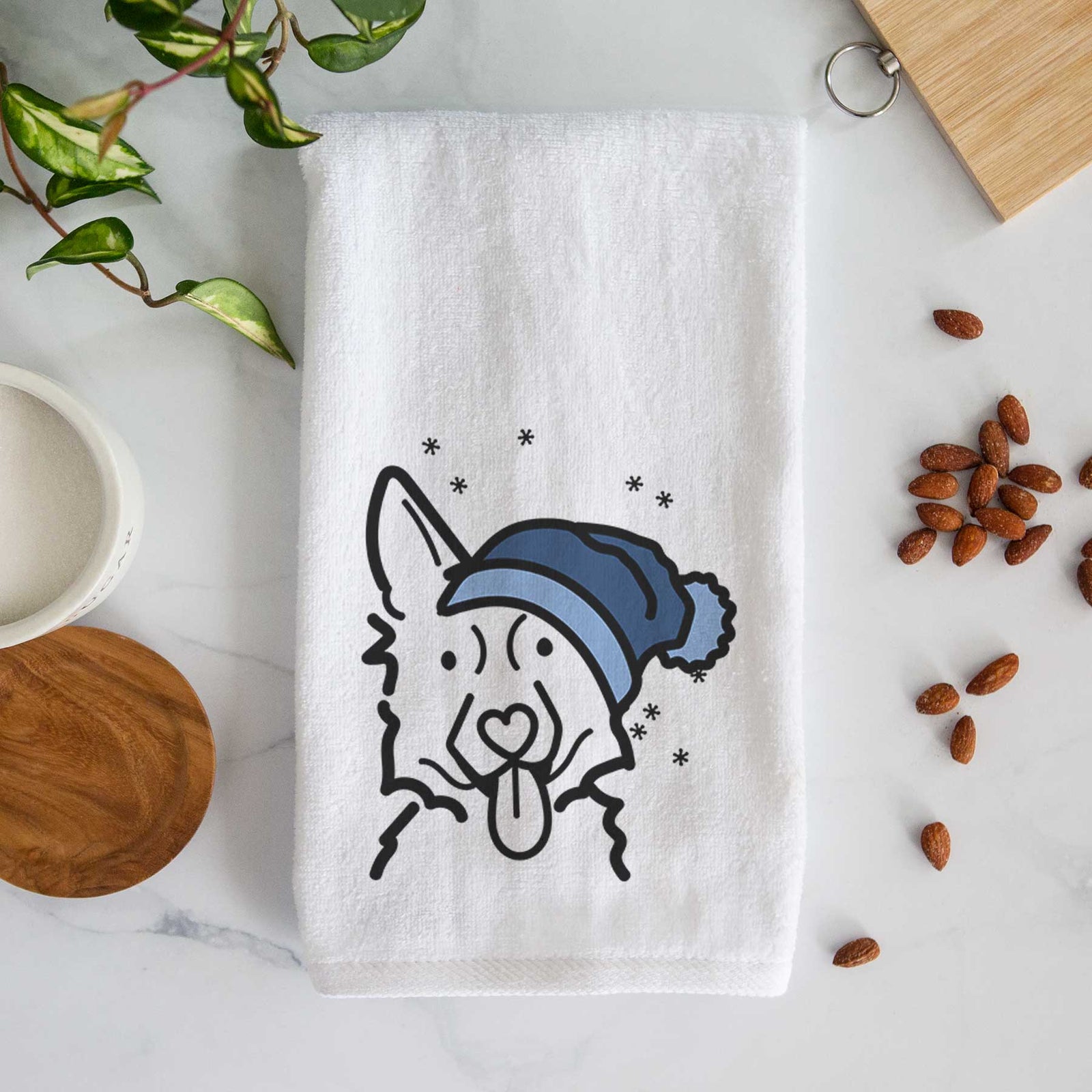 Minimalist line drawing of a German Shepherd wearing a winter beanie on a decorative hand towel