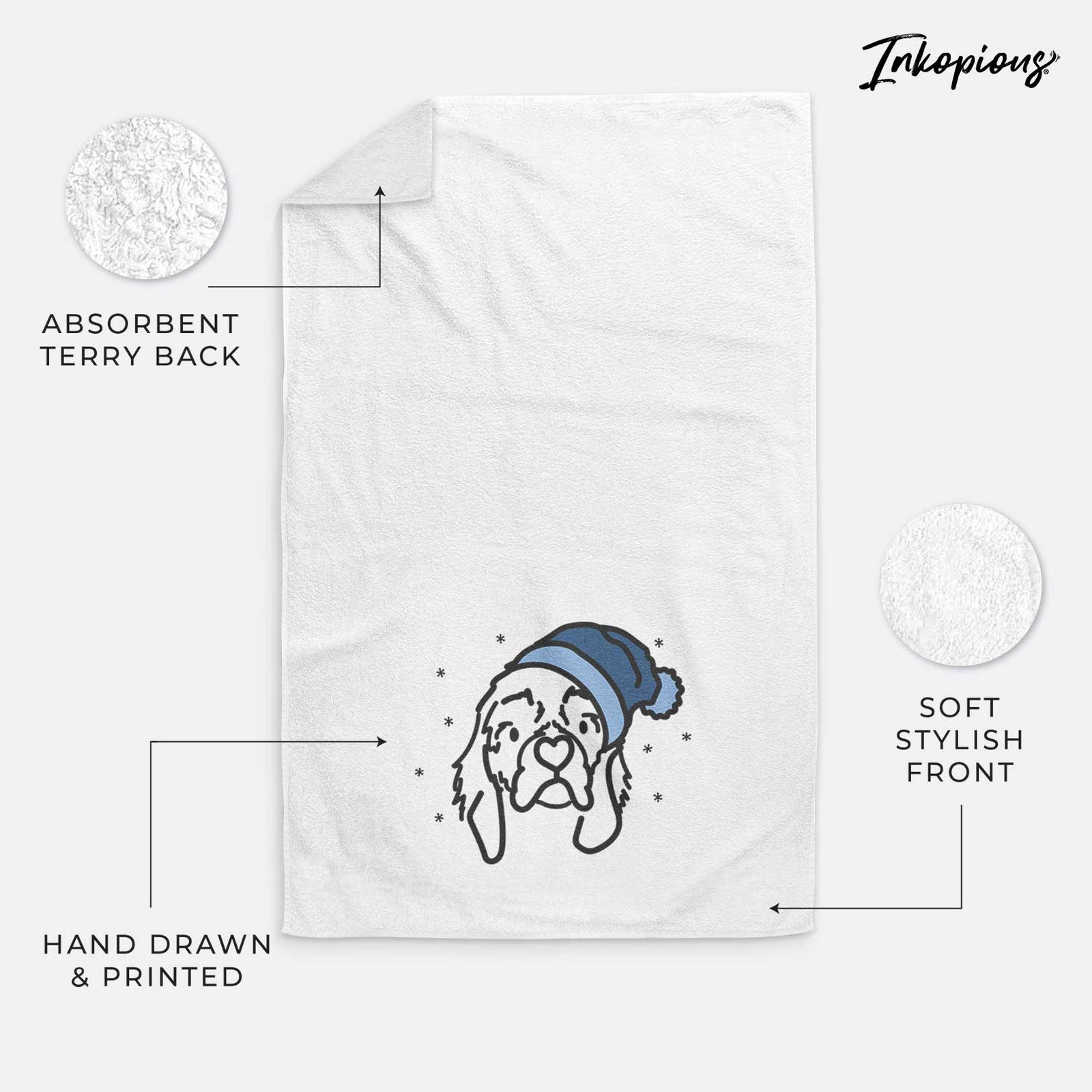 Minimalist line drawing of GiGi the Cocker Spaniel wearing a winter beanie on a decorative hand towel