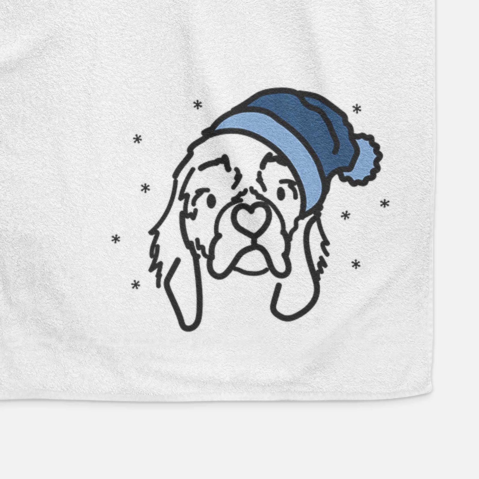 Minimalist line drawing of GiGi the Cocker Spaniel wearing a winter beanie on a decorative hand towel
