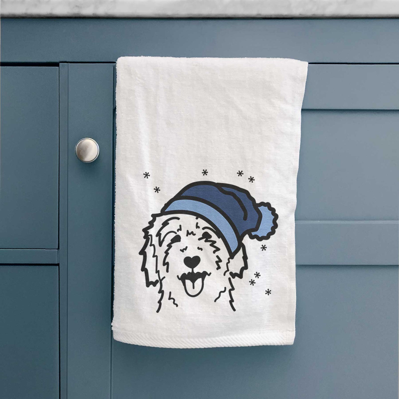 Minimalist line drawing of a Goldendoodle wearing a winter beanie on a decorative hand towel