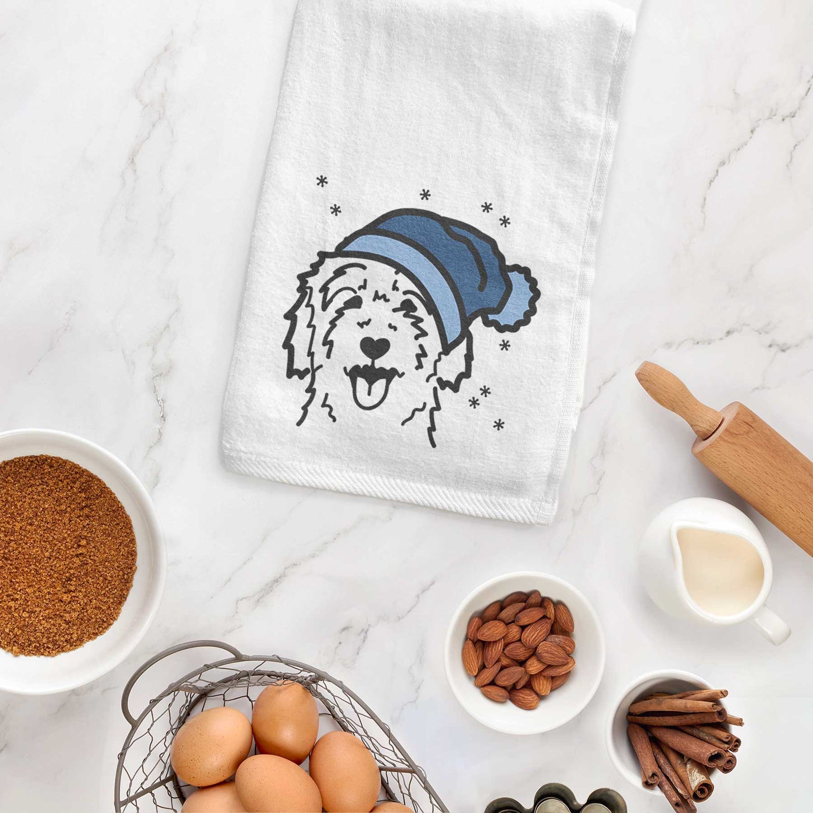 Minimalist line drawing of a Goldendoodle wearing a winter beanie on a decorative hand towel