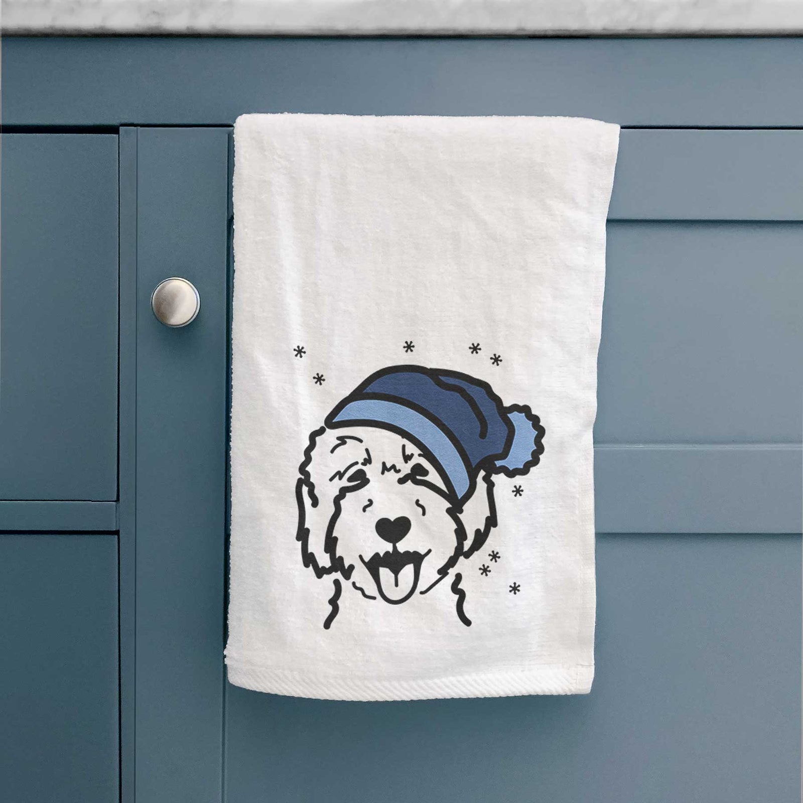 Minimalist line drawing of a Goldendoodle 2 wearing a winter beanie on a decorative hand towel