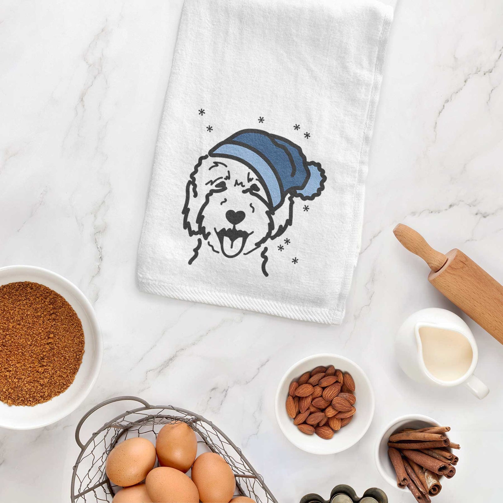Minimalist line drawing of a Goldendoodle 2 wearing a winter beanie on a decorative hand towel