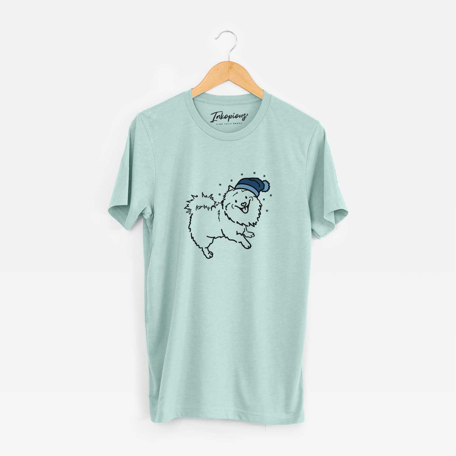 Minimalist line drawing of Goldie the Pomeranian Mix wearing a winter beanie on a Heather Sage Unisex crewneck
