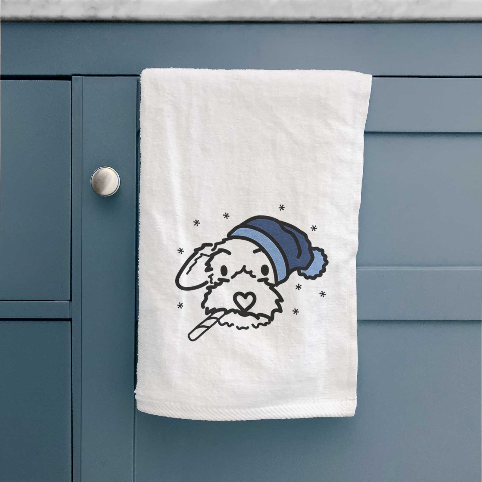 Minimalist line drawing of Gomer the Poodle Mix wearing a winter beanie on a decorative hand towel