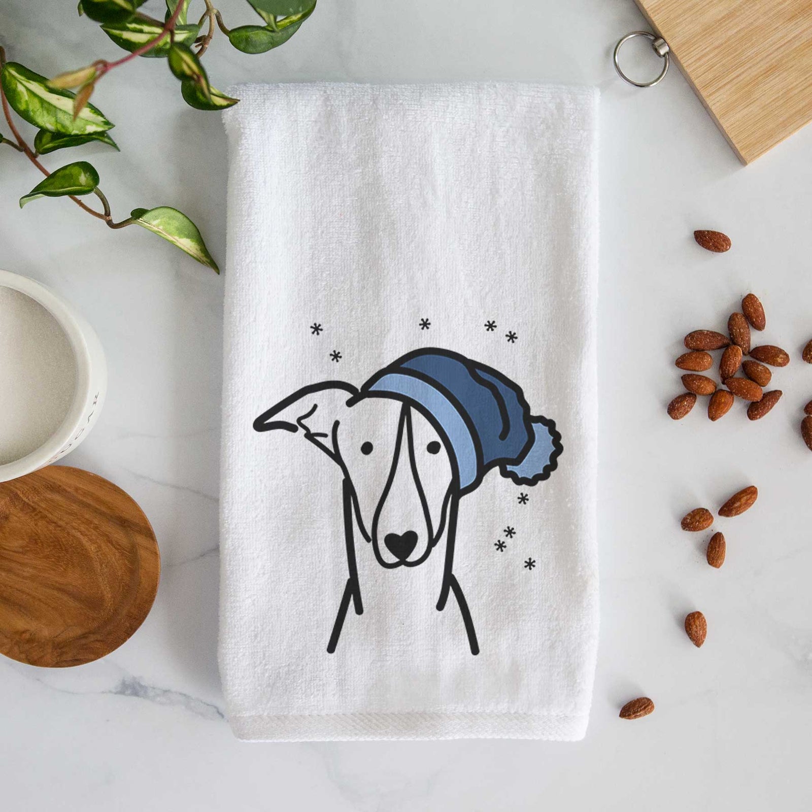 Minimalist line drawing of a Greyhound wearing a winter beanie on a decorative hand towel