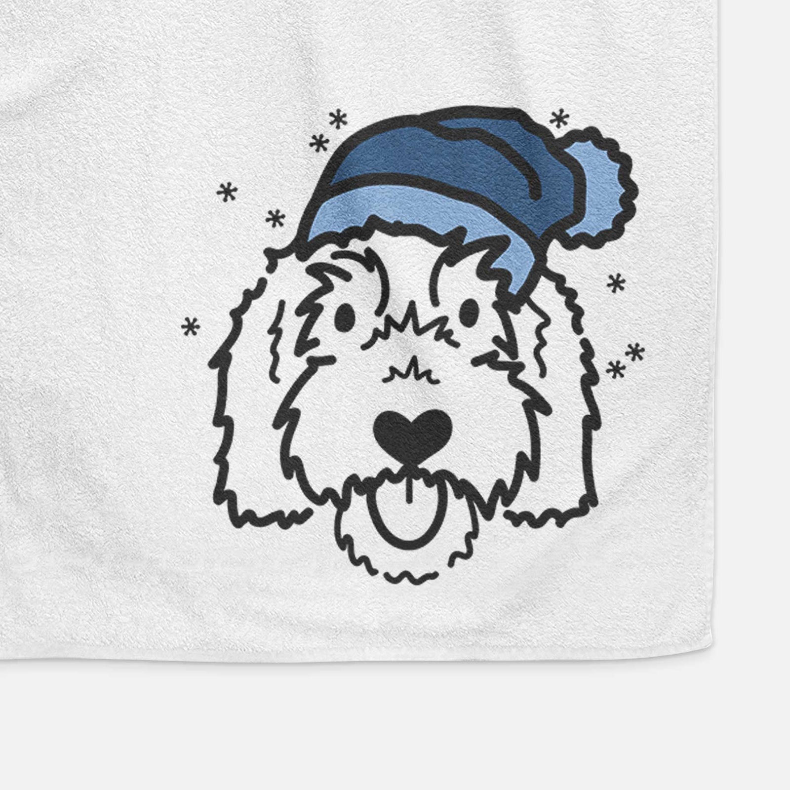 Minimalist line drawing of Gus the Goldendoodle wearing a winter beanie on a decorative hand towel