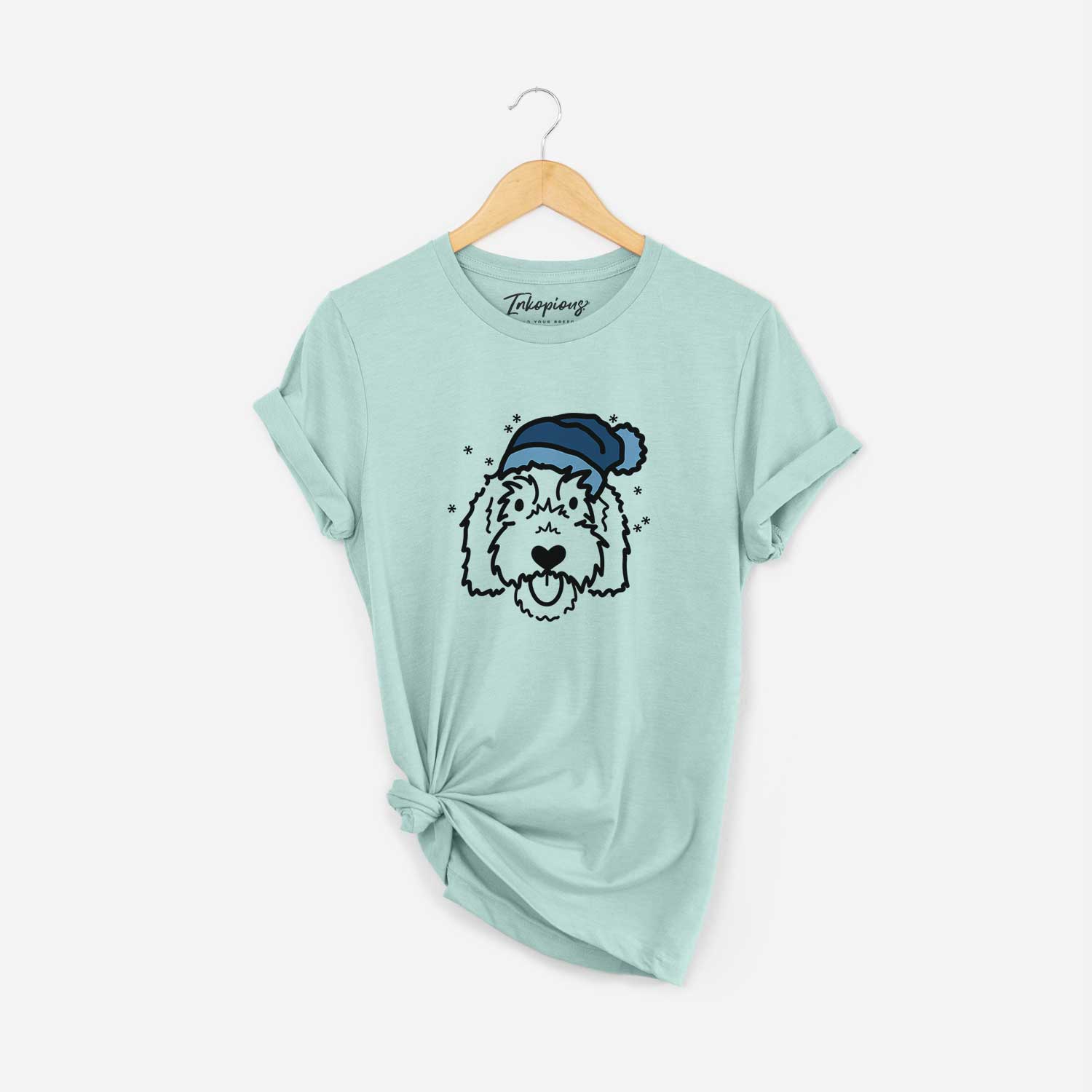 Minimalist line drawing of Gus the Goldendoodle wearing a winter beanie on a Heather Sage Unisex crewneck