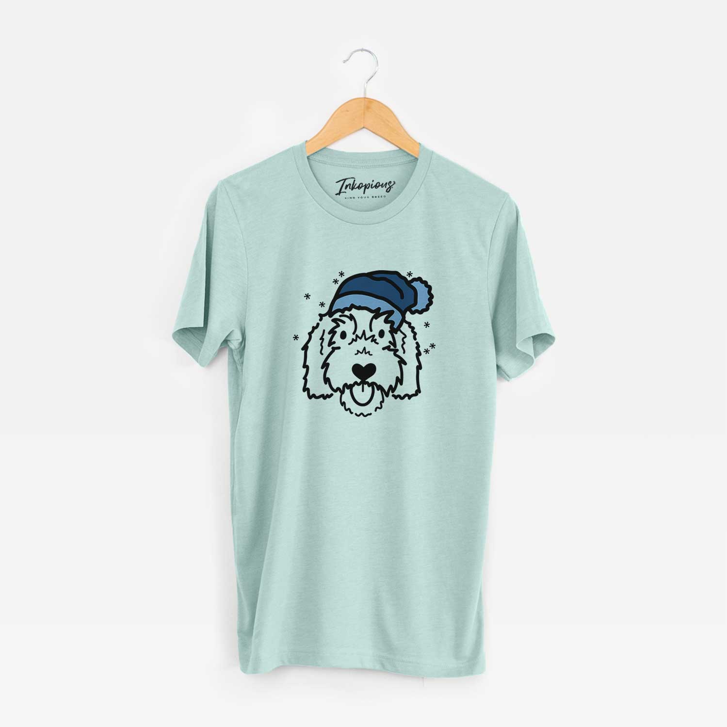 Minimalist line drawing of Gus the Goldendoodle wearing a winter beanie on a Heather Sage Unisex crewneck