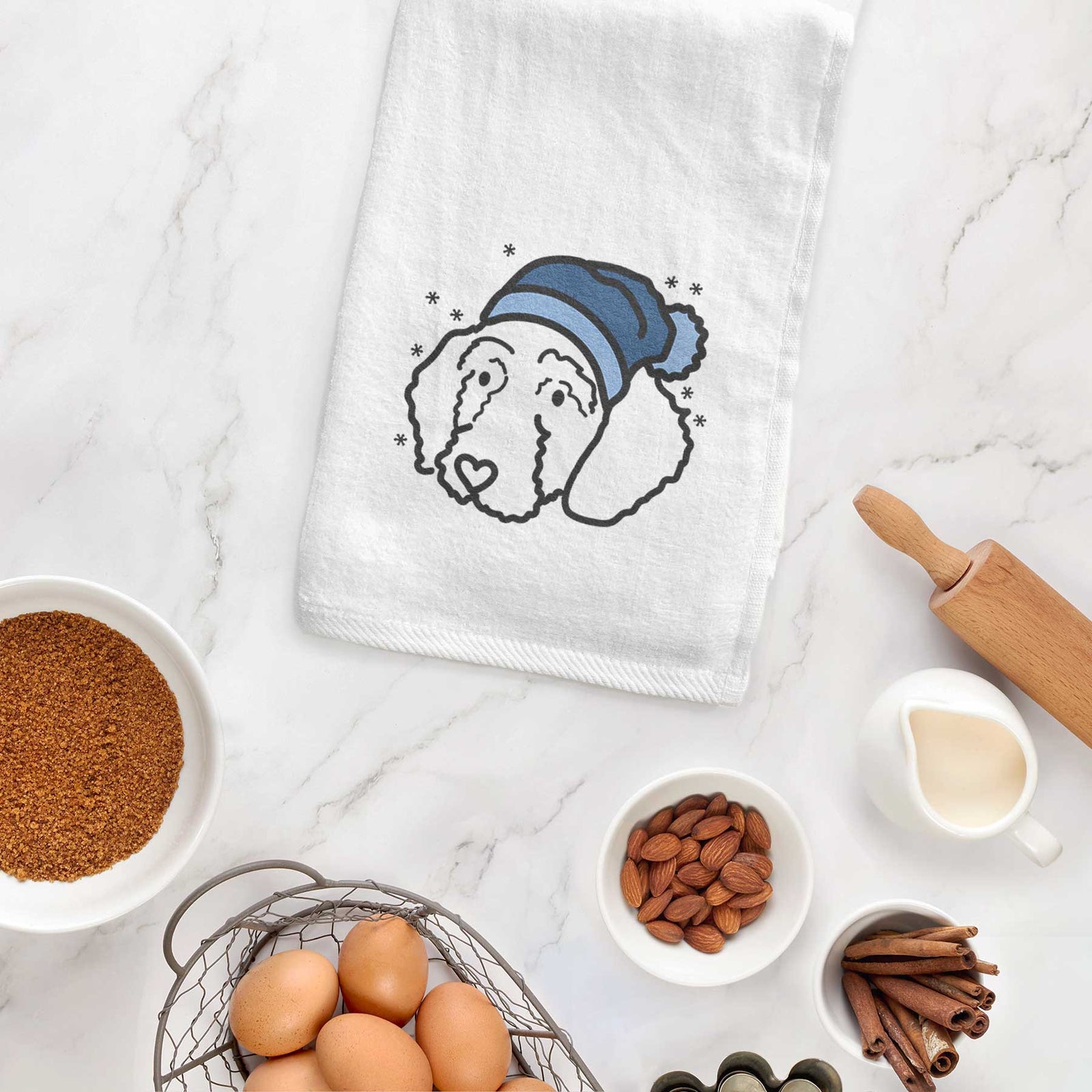 Minimalist line drawing of Hanna the Goldendoodle wearing a winter beanie on a decorative hand towel