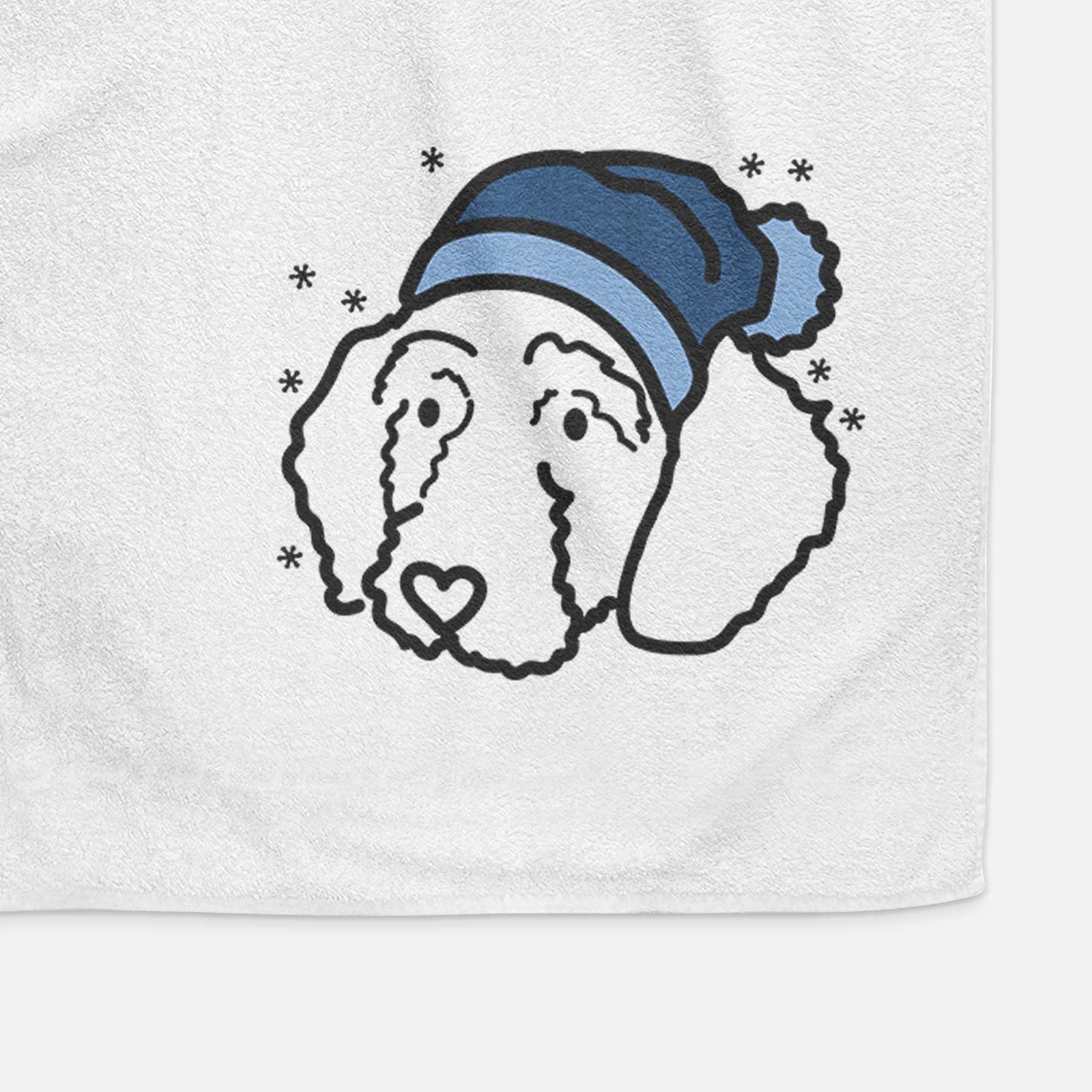 Minimalist line drawing of Hanna the Goldendoodle wearing a winter beanie on a decorative hand towel