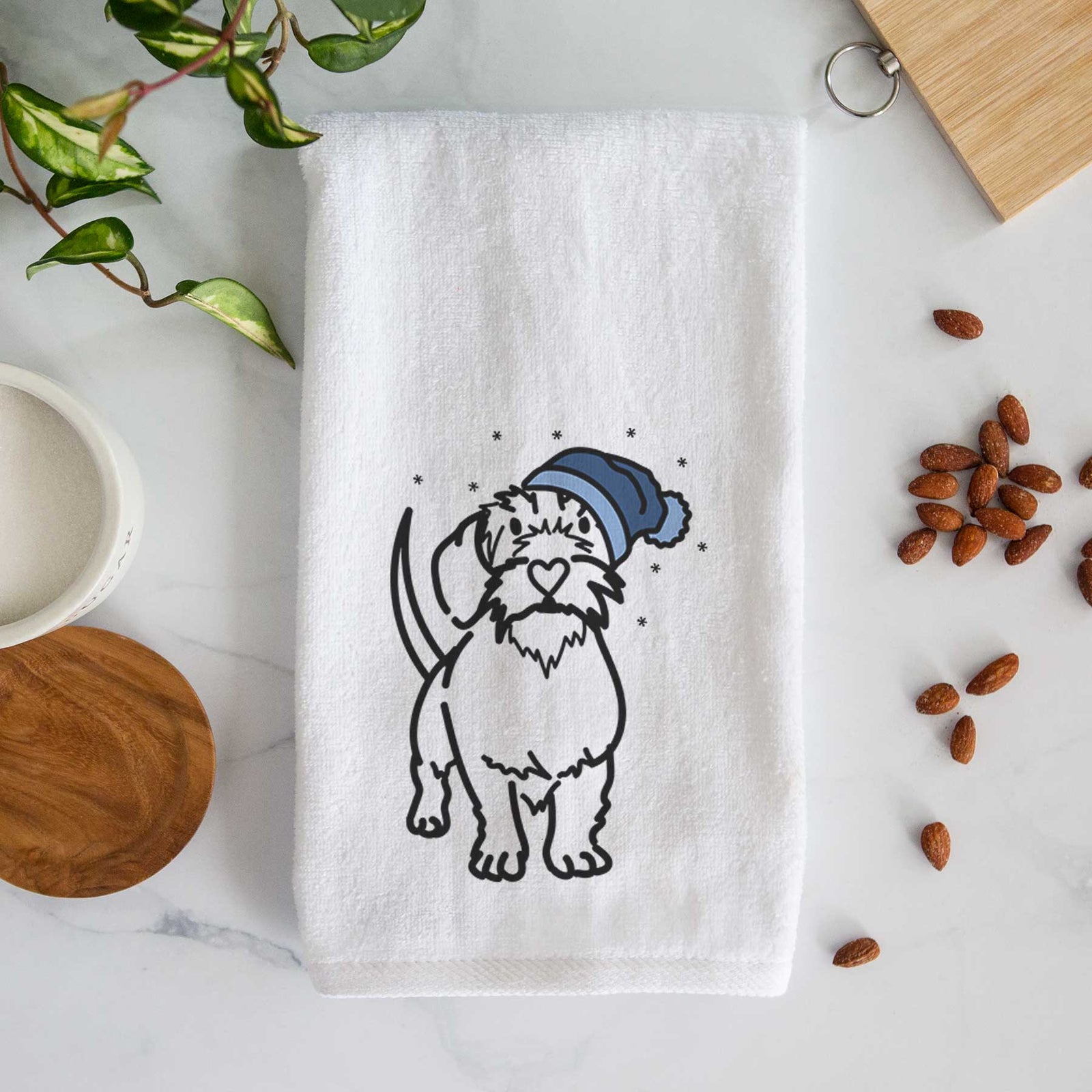 Minimalist line drawing of Henry the Wire Dachshund wearing a winter beanie on a decorative hand towel