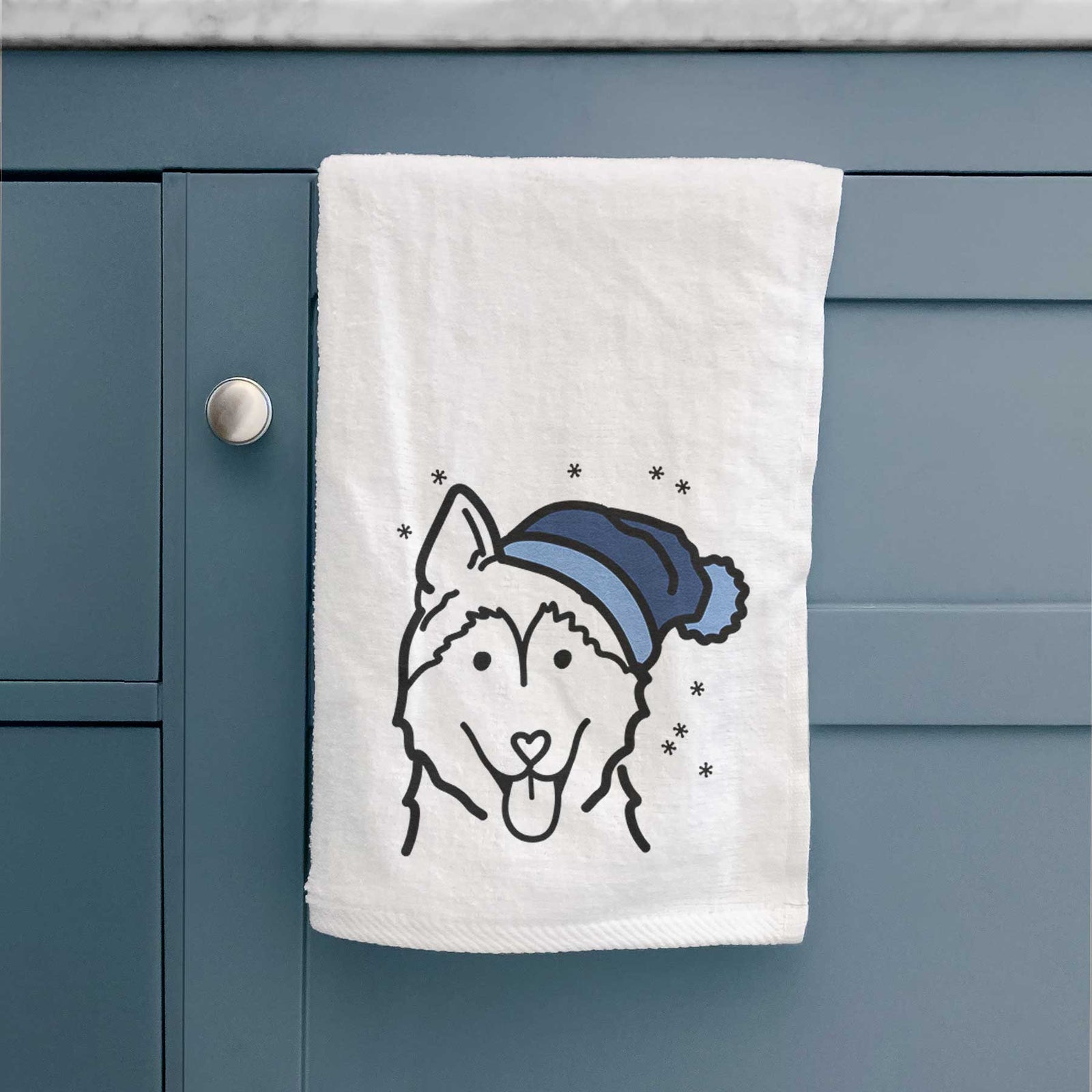 Minimalist line drawing of a Siberian Husky wearing a winter beanie on a decorative hand towel