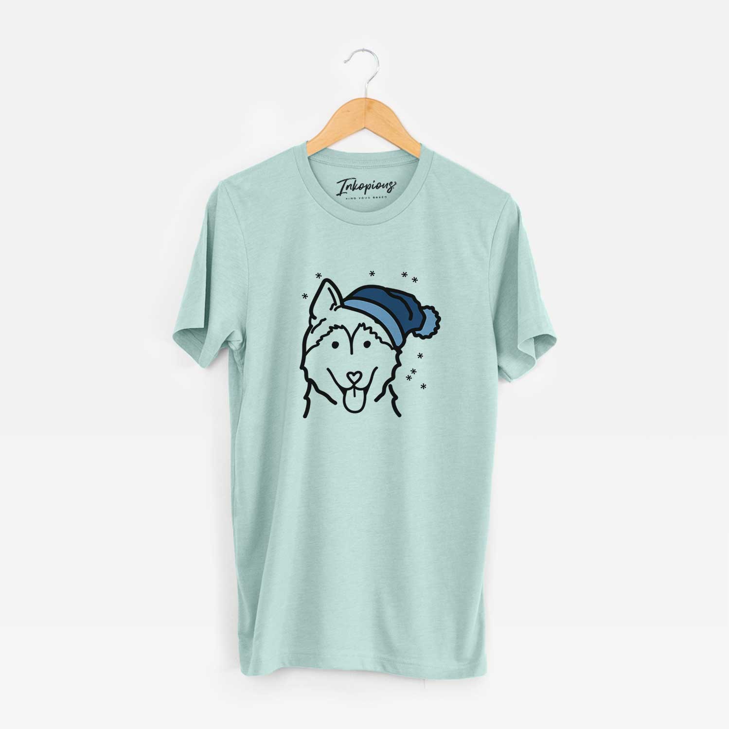 Minimalist line drawing of a Siberian Husky wearing a winter beanie on a Heather Sage Unisex crewneck