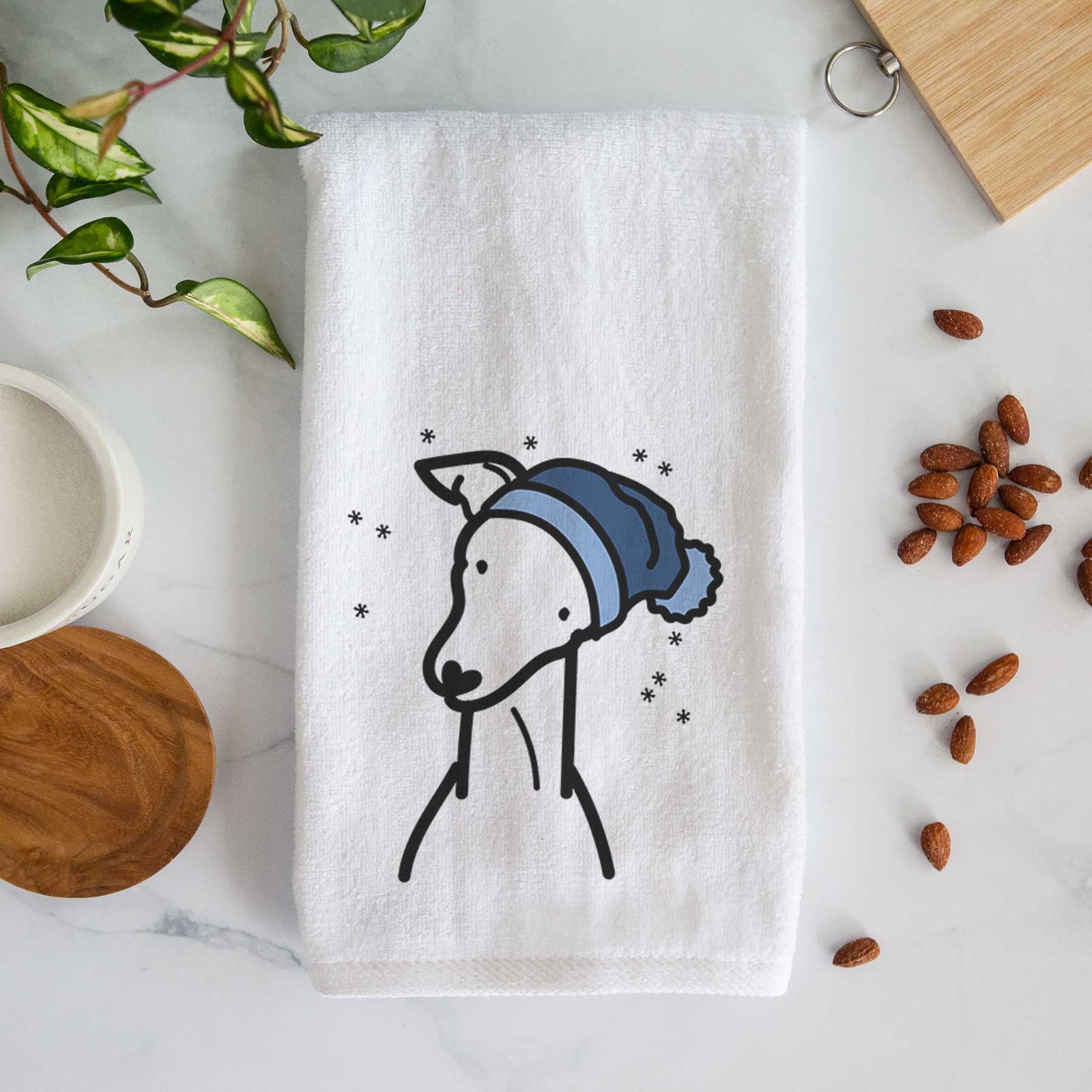 Minimalist line drawing of an Italian Greyhound wearing a winter beanie on a decorative hand towel