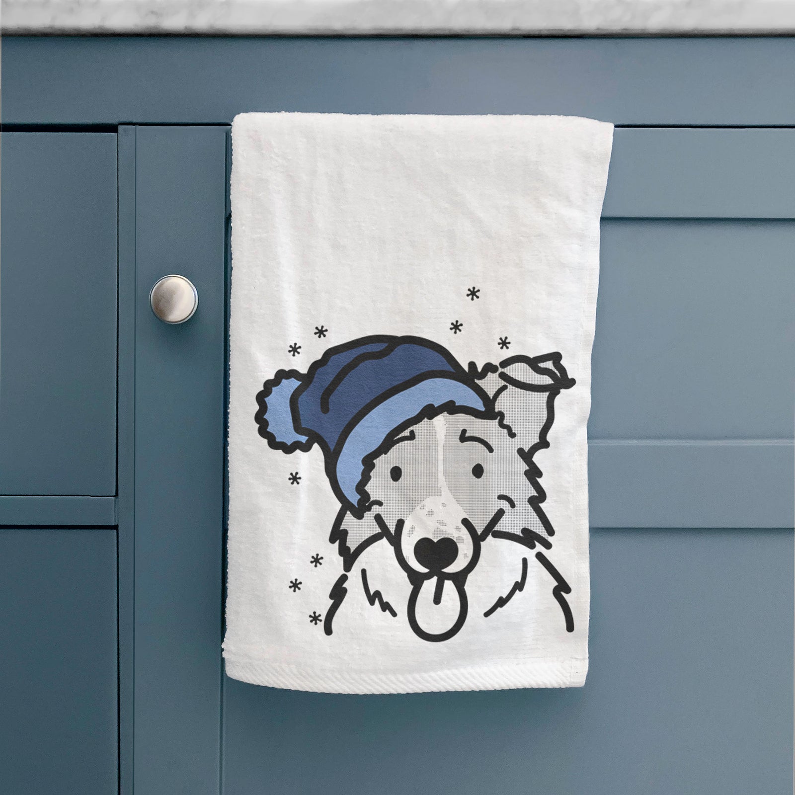Minimalist line drawing of Jam the Border Collie wearing a winter beanie on a decorative hand towel