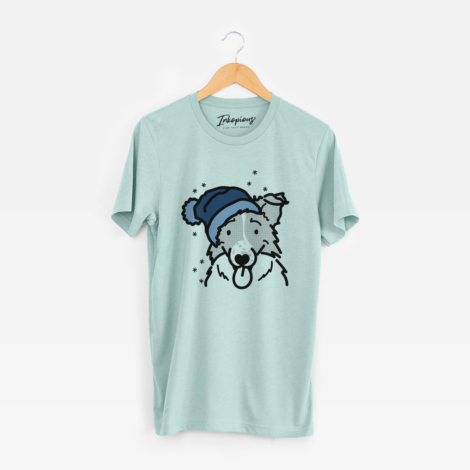 Minimalist line drawing of Jam the Border Collie wearing a winter beanie on a Heather Sage Unisex crewneck