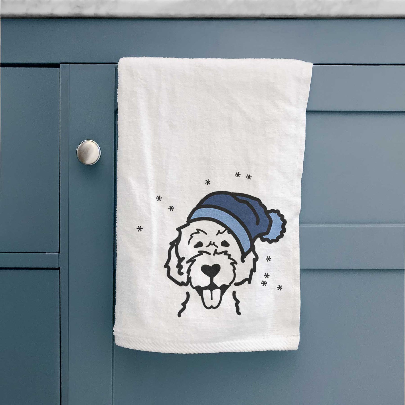 Minimalist line drawing of a Labradoodle wearing a winter beanie on a decorative hand towel