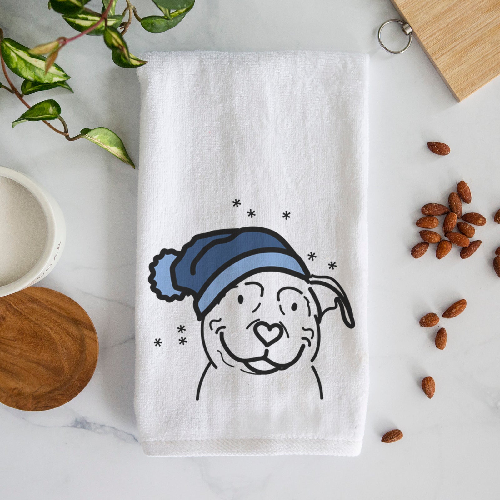 Minimalist line drawing of Lady the American Pitbull Terrier wearing a winter beanie on a decorative hand towel