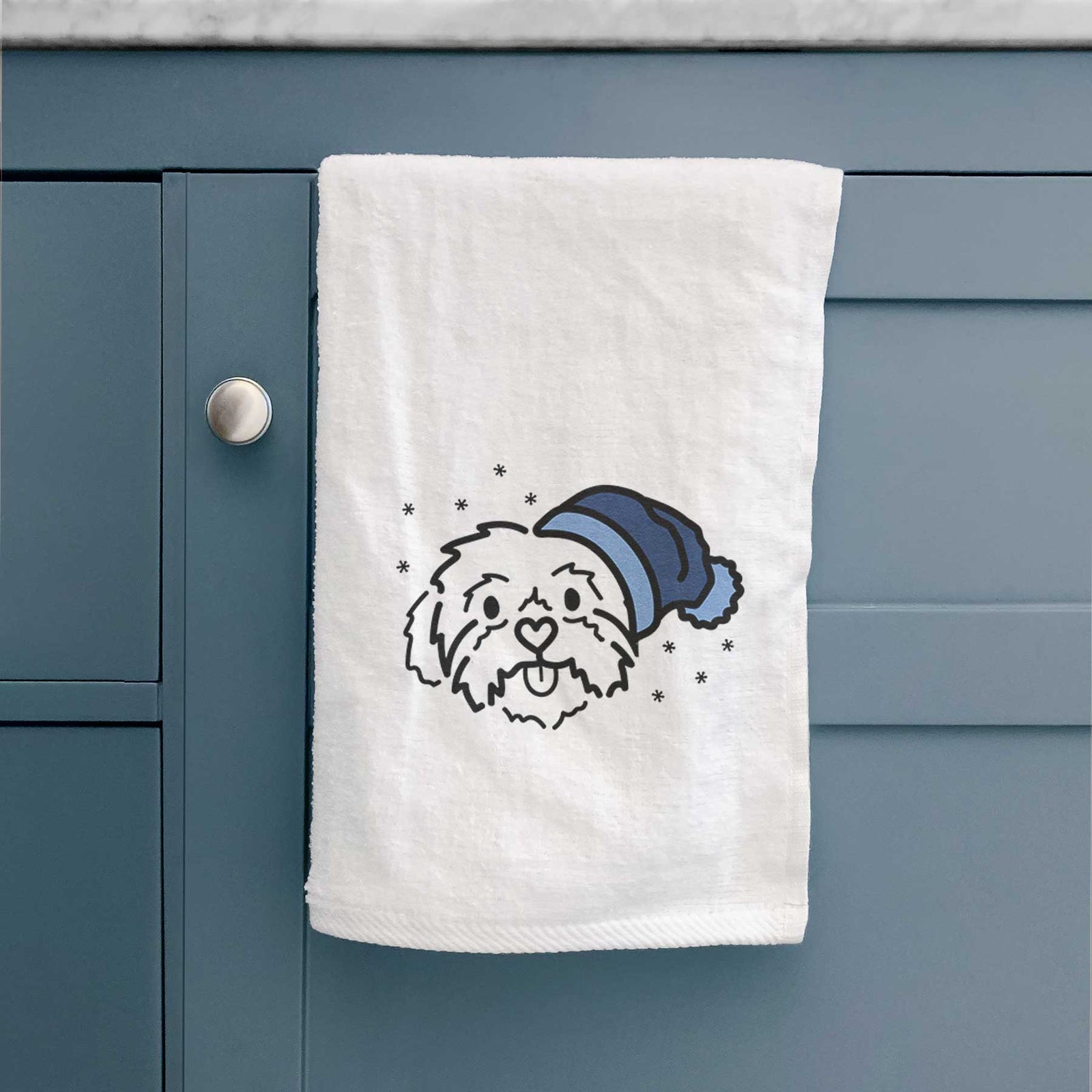 Minimalist line drawing of Leo the Shih Tzu wearing a winter beanie on a decorative hand towel