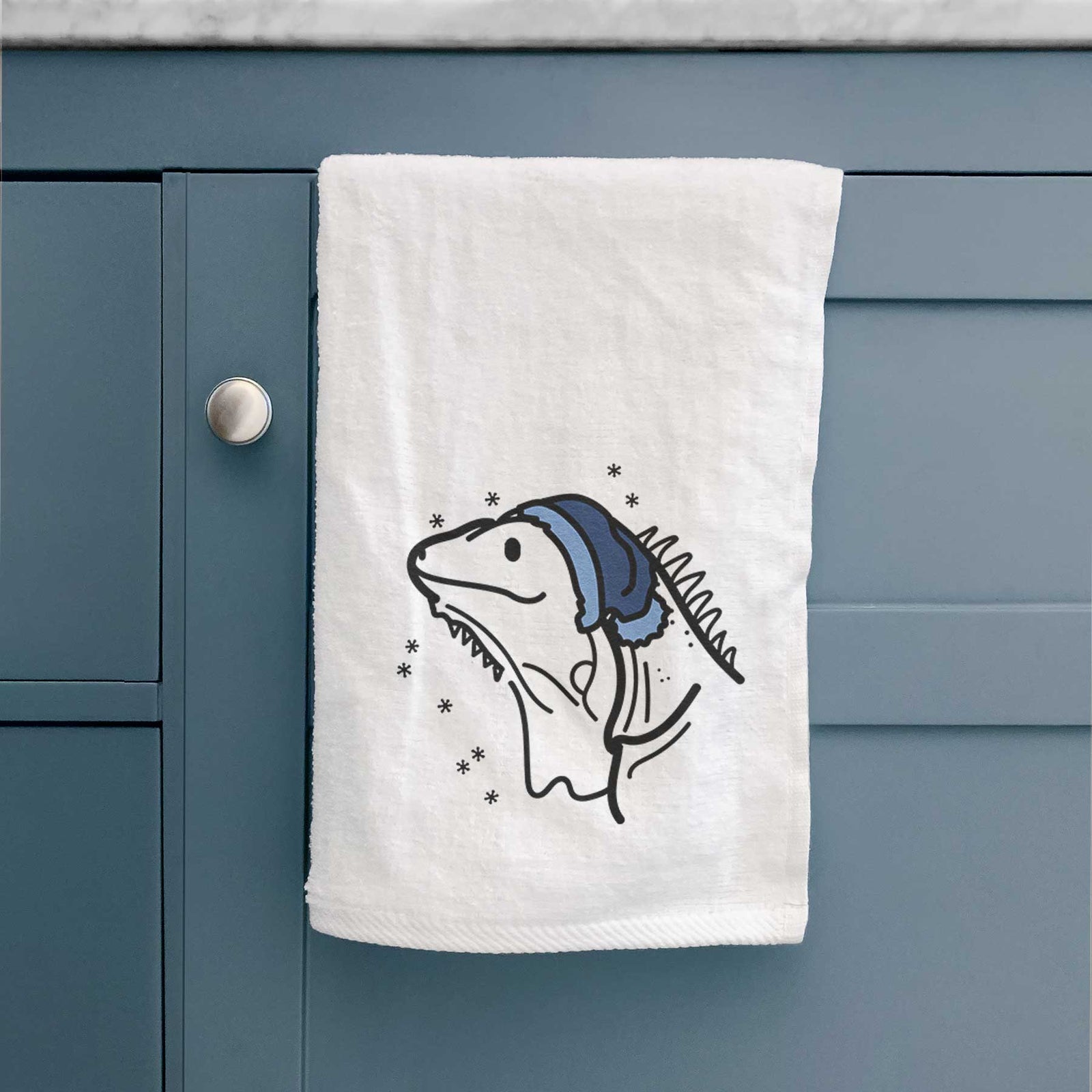 Minimalist line drawing of Louie the Iguana wearing a winter beanie on a decorative hand towel