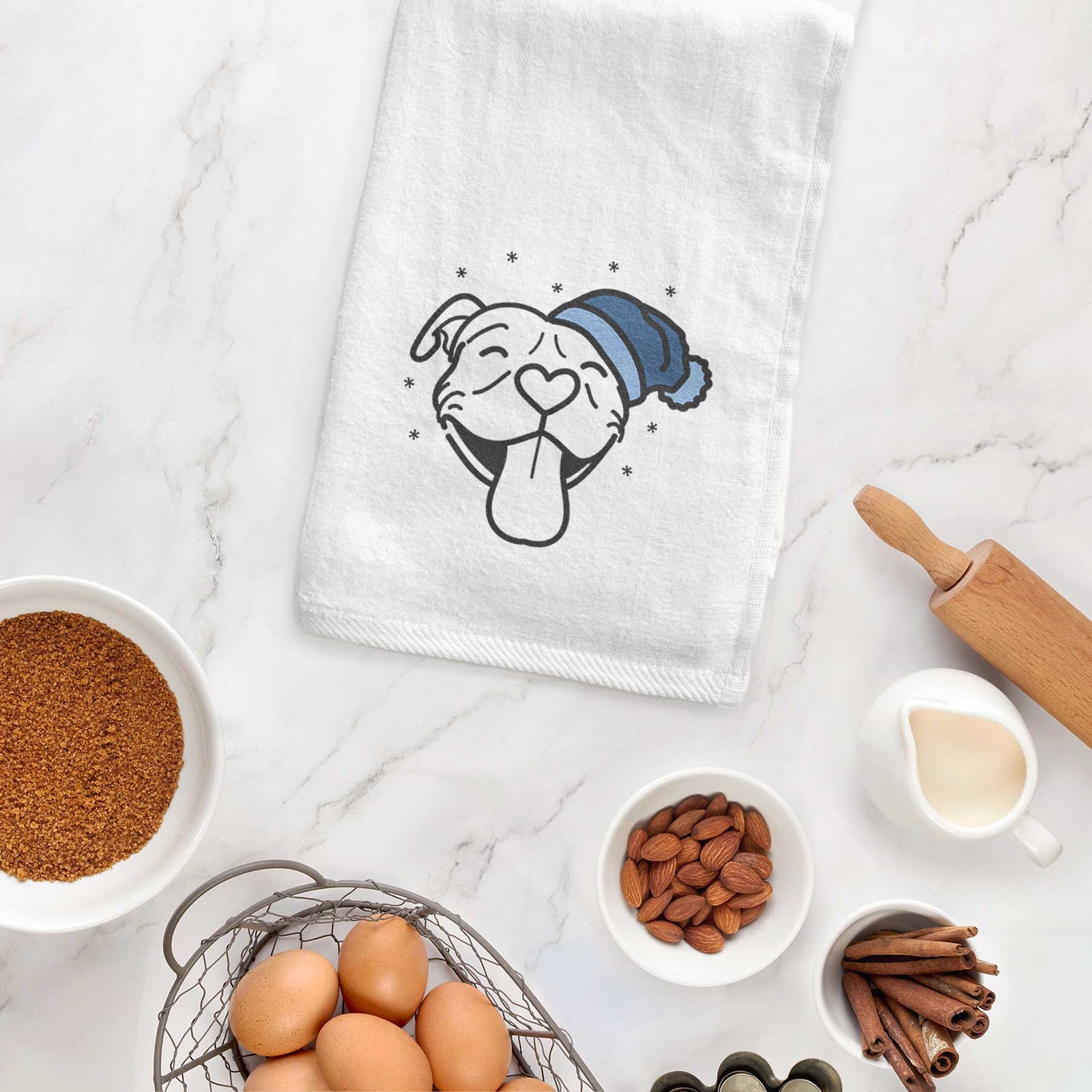 Minimalist line drawing of Louie the Pitbull wearing a winter beanie on a decorative hand towel
