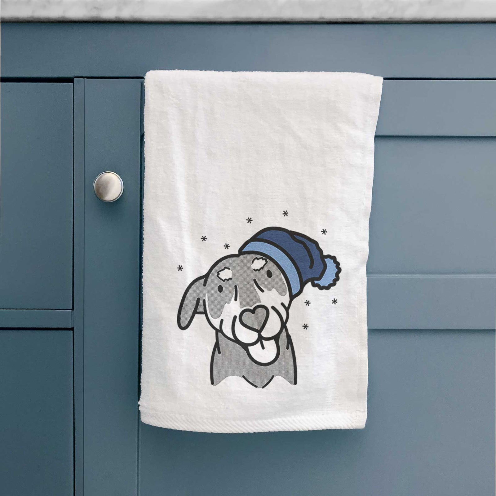 Minimalist line drawing of Lousia the Mixed Breed wearing a winter beanie on a decorative hand towel