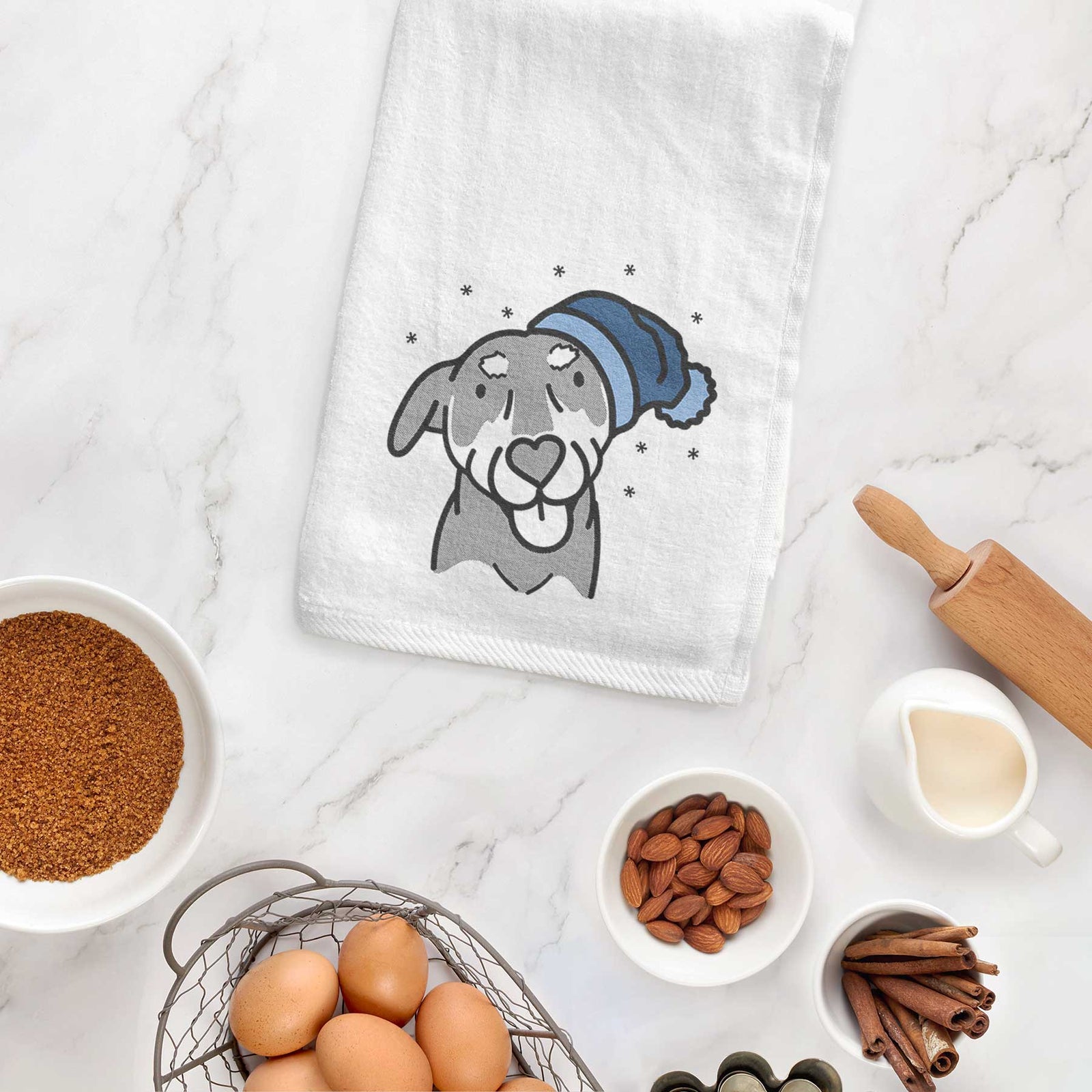 Minimalist line drawing of Lousia the Mixed Breed wearing a winter beanie on a decorative hand towel