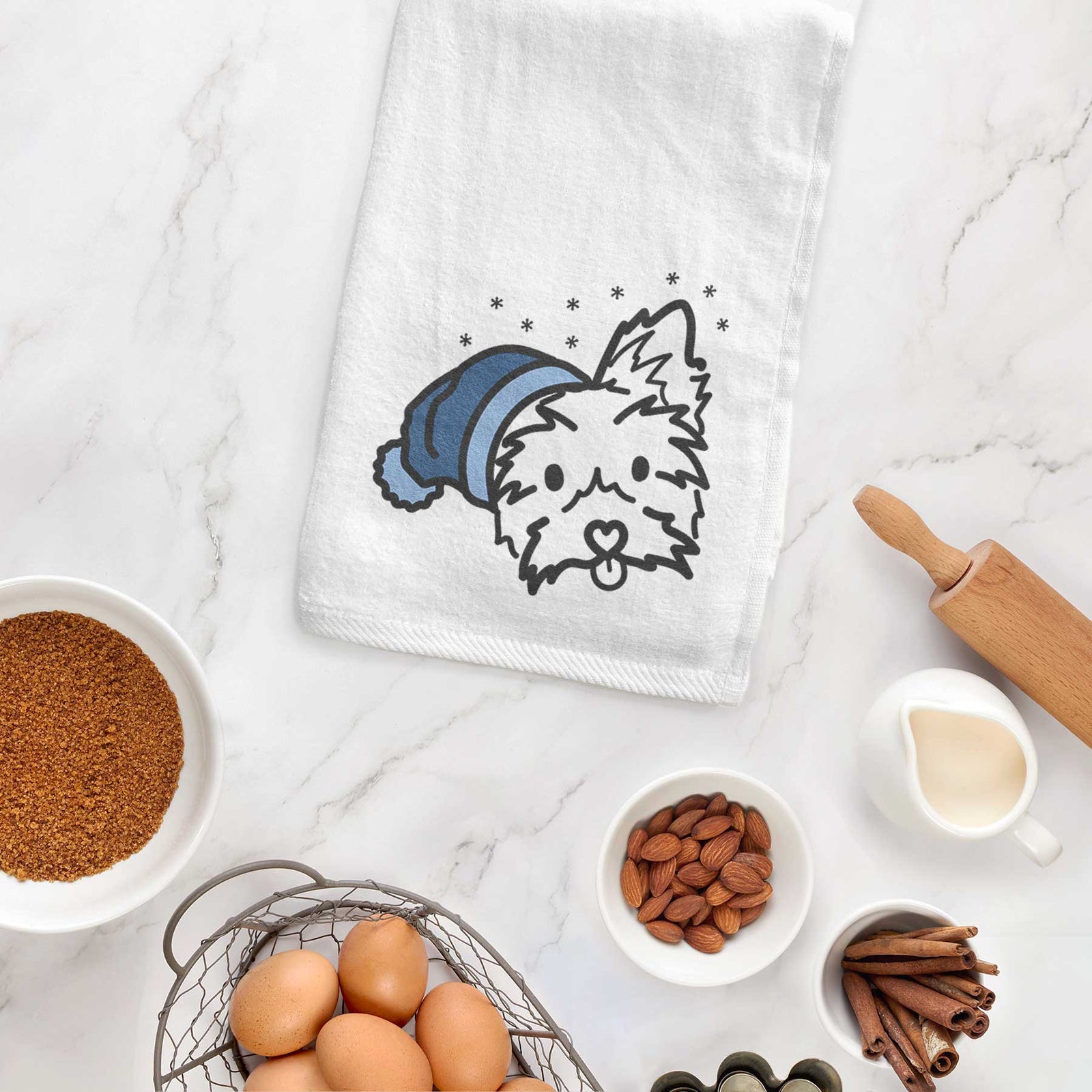 Minimalist line drawing of Luna the Yorkshire Terrier wearing a winter beanie on a decorative hand towel