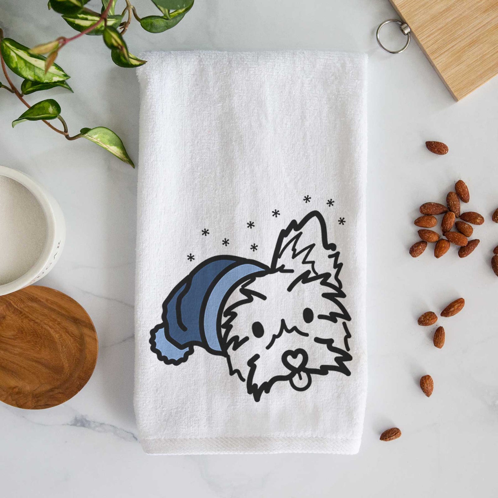 Minimalist line drawing of Luna the Yorkshire Terrier wearing a winter beanie on a decorative hand towel