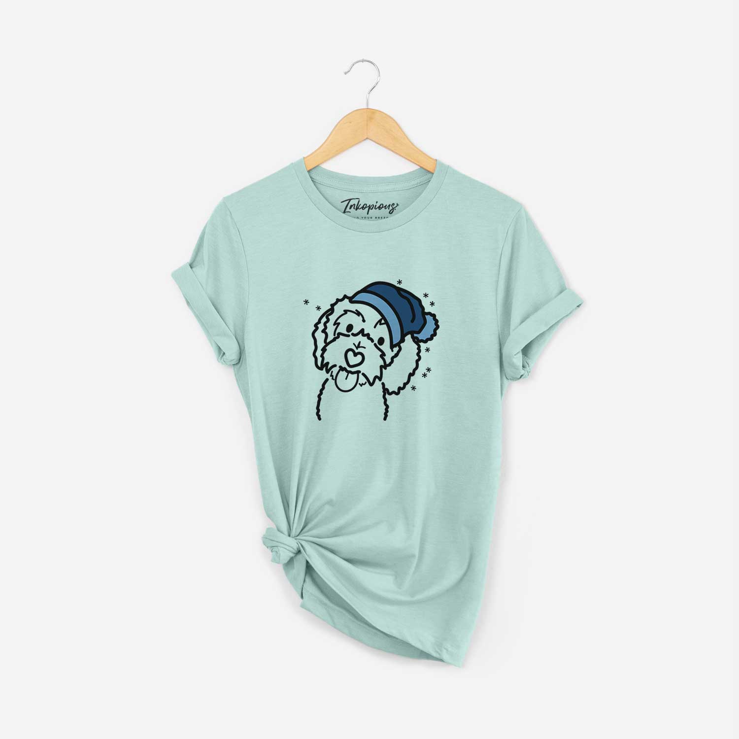 Minimalist line drawing of Mabel the Bernedoodle wearing a winter beanie on a Heather Sage Unisex crewneck