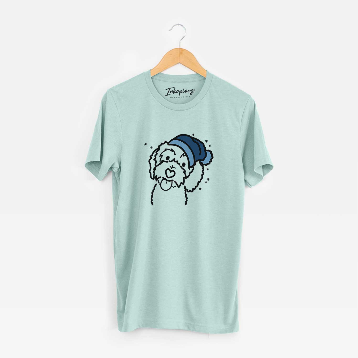 Minimalist line drawing of Mabel the Bernedoodle wearing a winter beanie on a Heather Sage Unisex crewneck