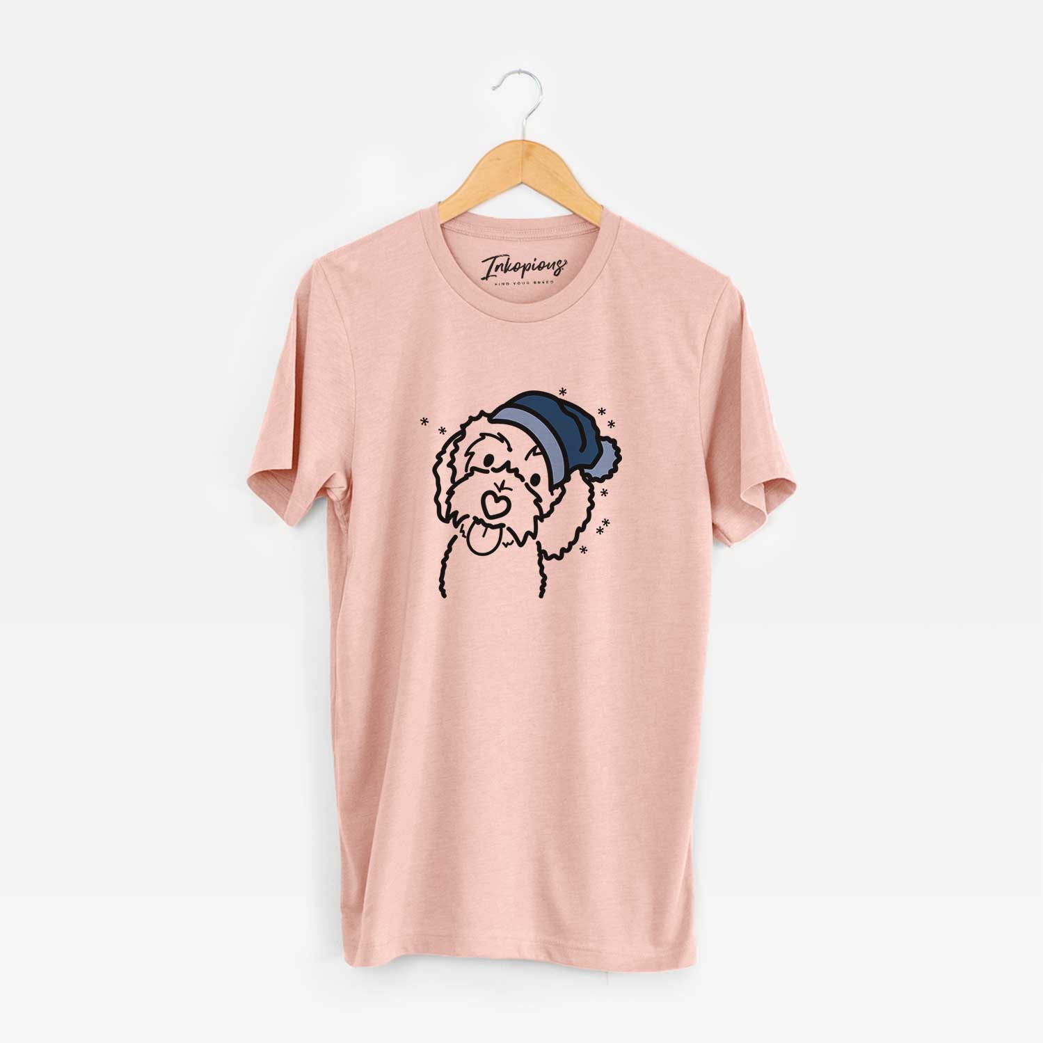 Minimalist line drawing of Mabel the Bernedoodle wearing a winter beanie on a Peach Unisex crewneck