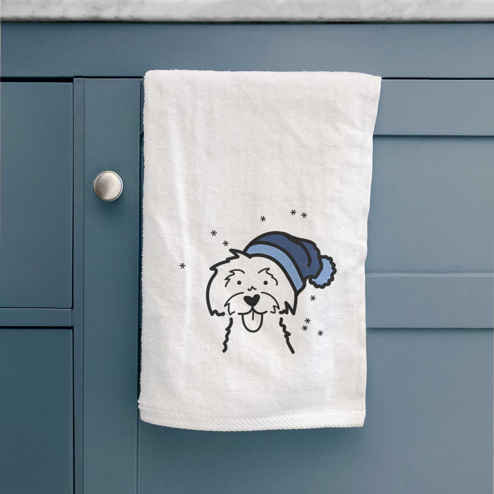 Minimalist line drawing of a Maltese wearing a winter beanie on a decorative hand towel