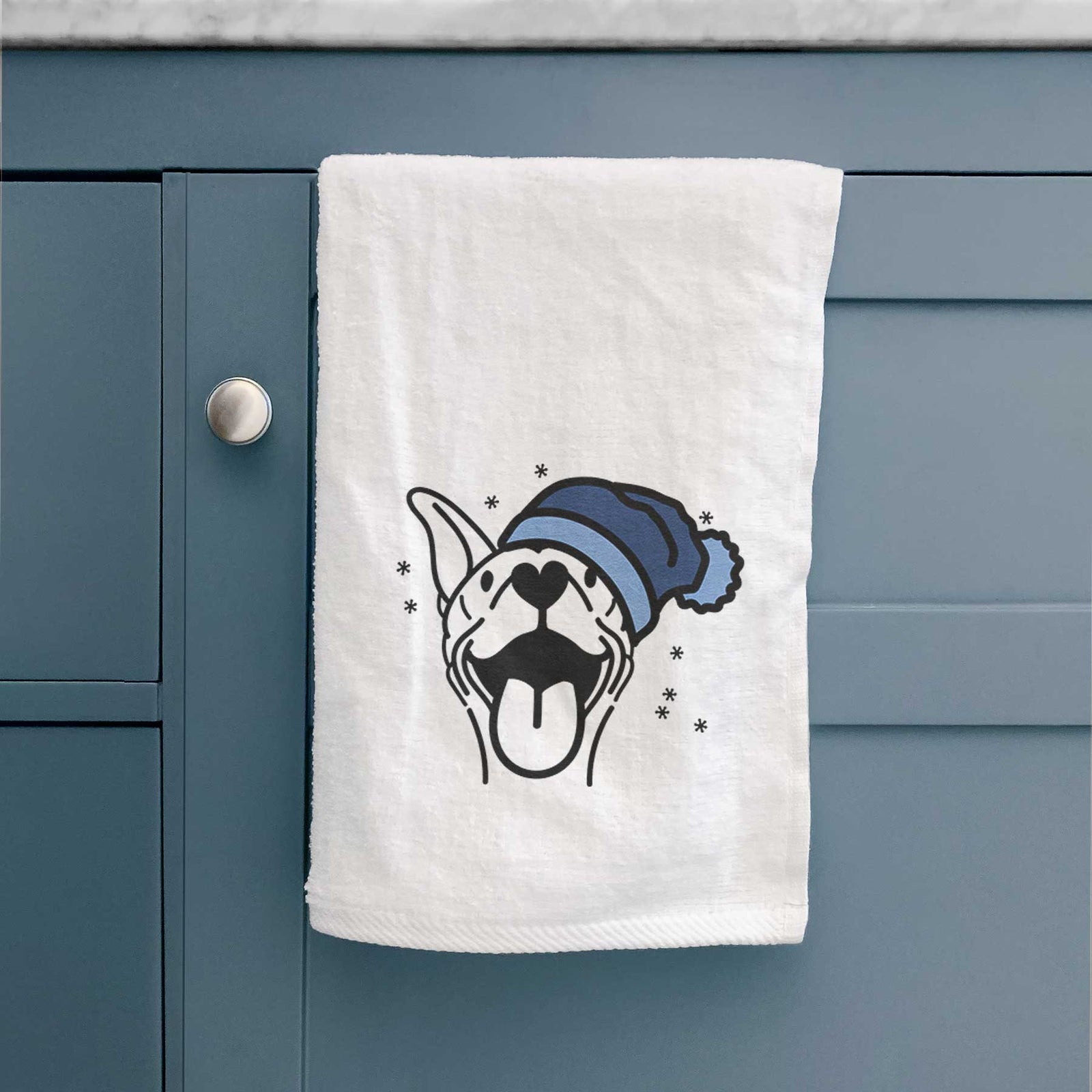 Minimalist line drawing of Merlin the Basenji wearing a winter beanie on a decorative hand towel