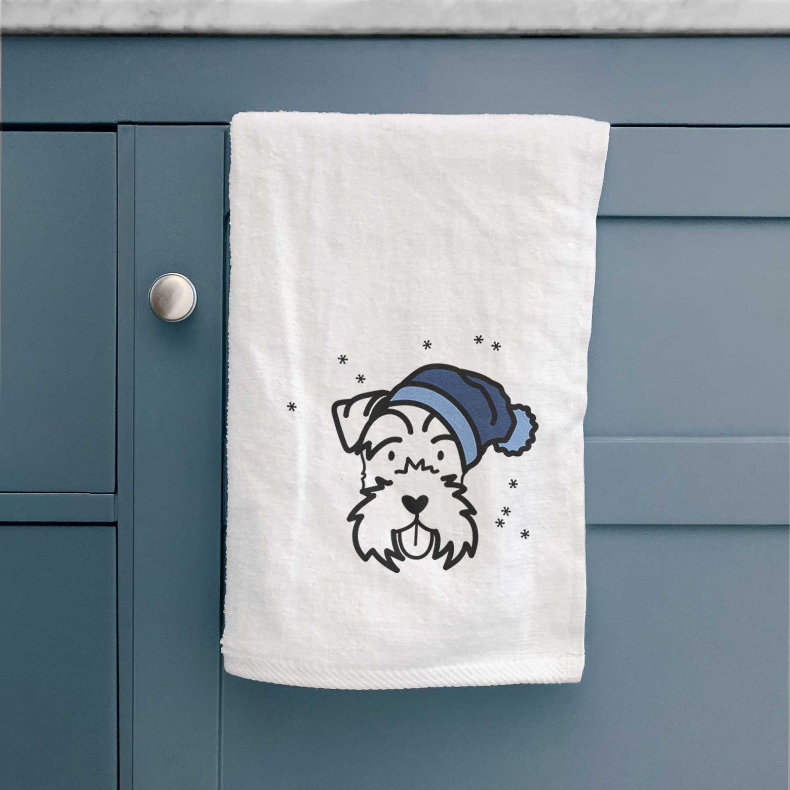 Minimalist line drawing of a Miniature Schnauzer wearing a winter beanie on a decorative hand towel