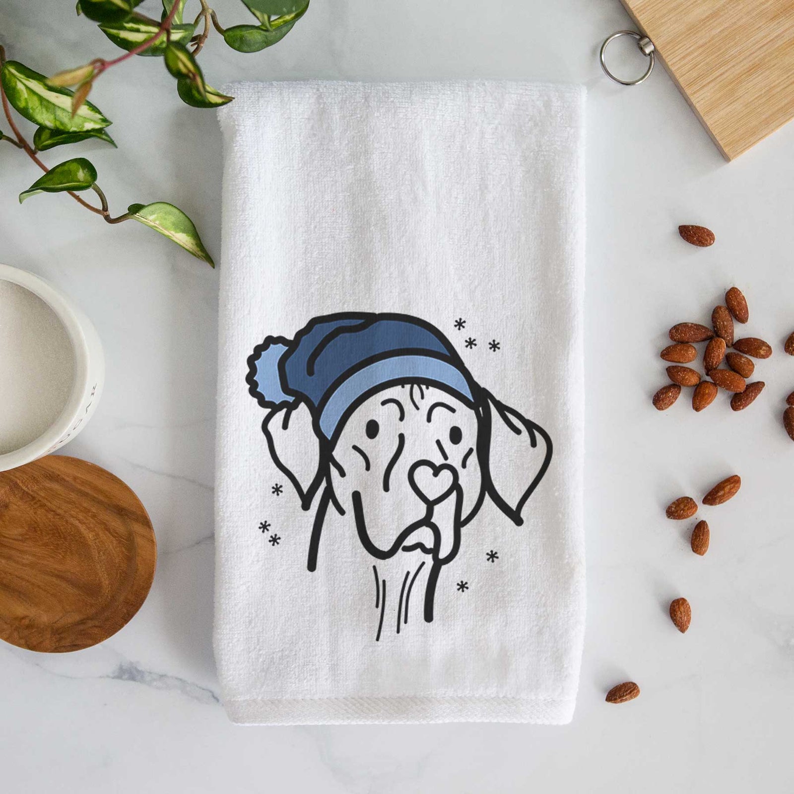 Minimalist line drawing of Moose the Vizsla wearing a winter beanie on a decorative hand towel