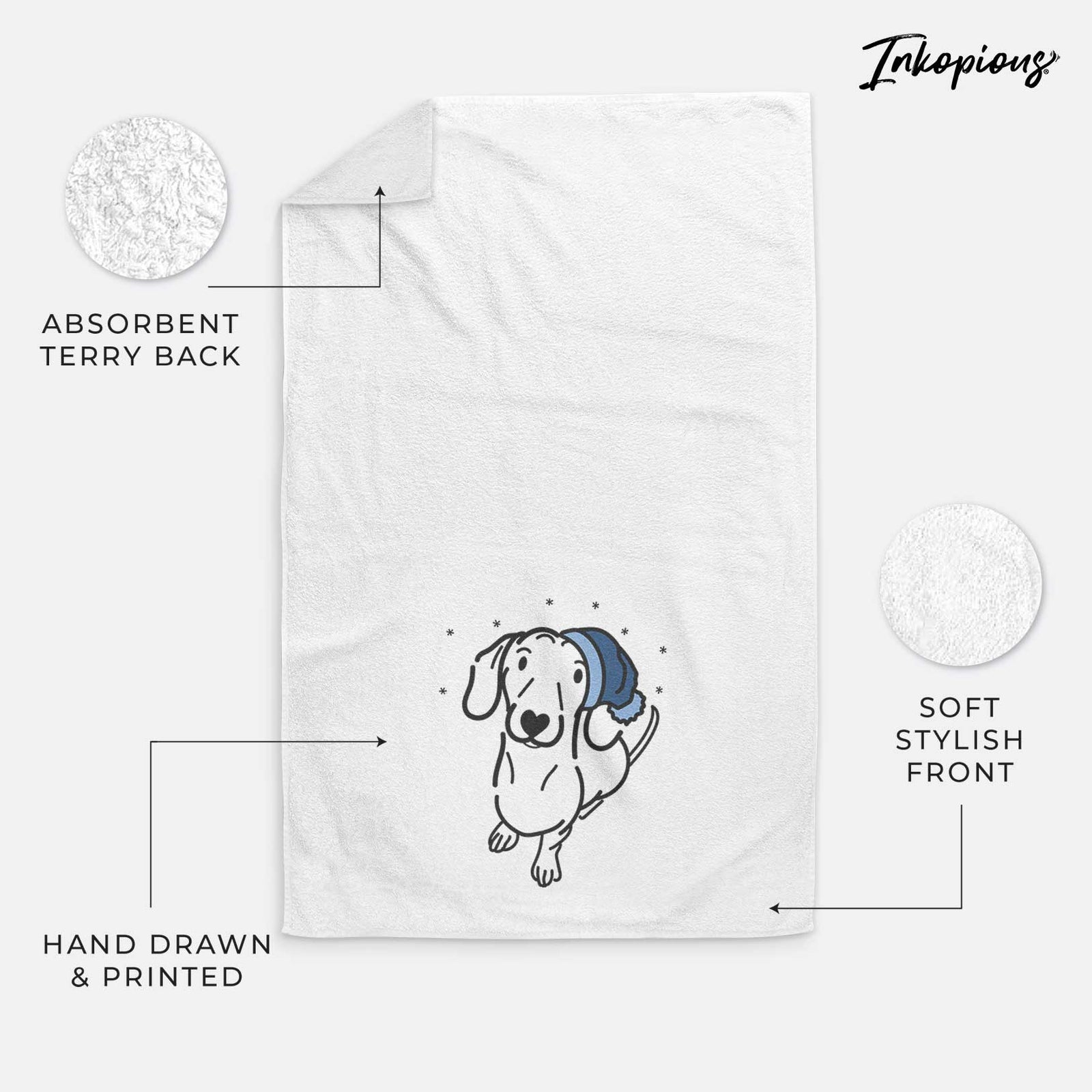 Minimalist line drawing of Moxie the Dachshund wearing a winter beanie on a decorative hand towel