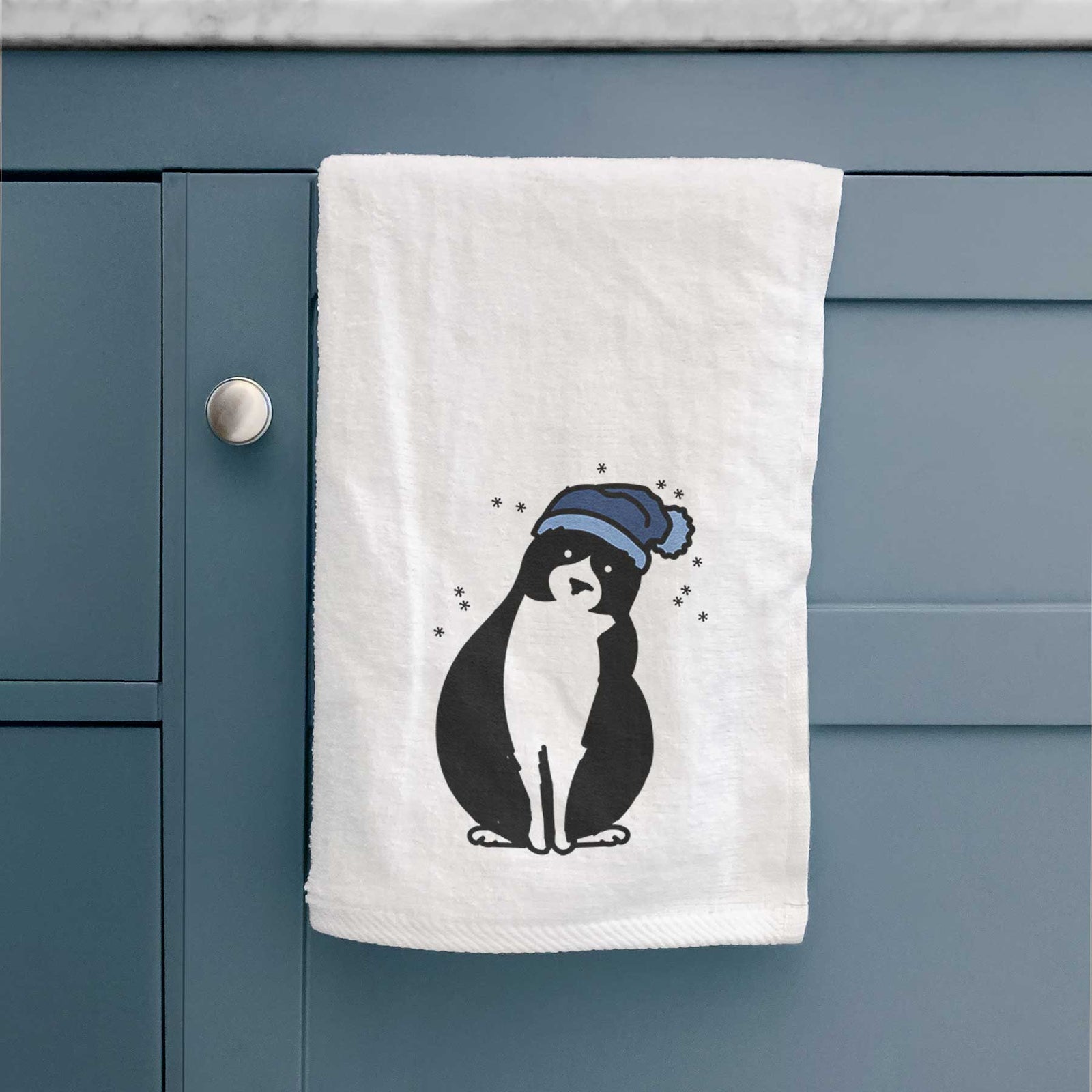 Minimalist line drawing of Oliver the Tuxedo Cat wearing a winter beanie on a decorative hand towel