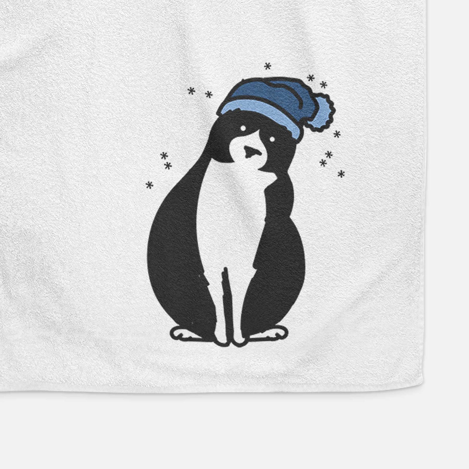 Minimalist line drawing of Oliver the Tuxedo Cat wearing a winter beanie on a decorative hand towel