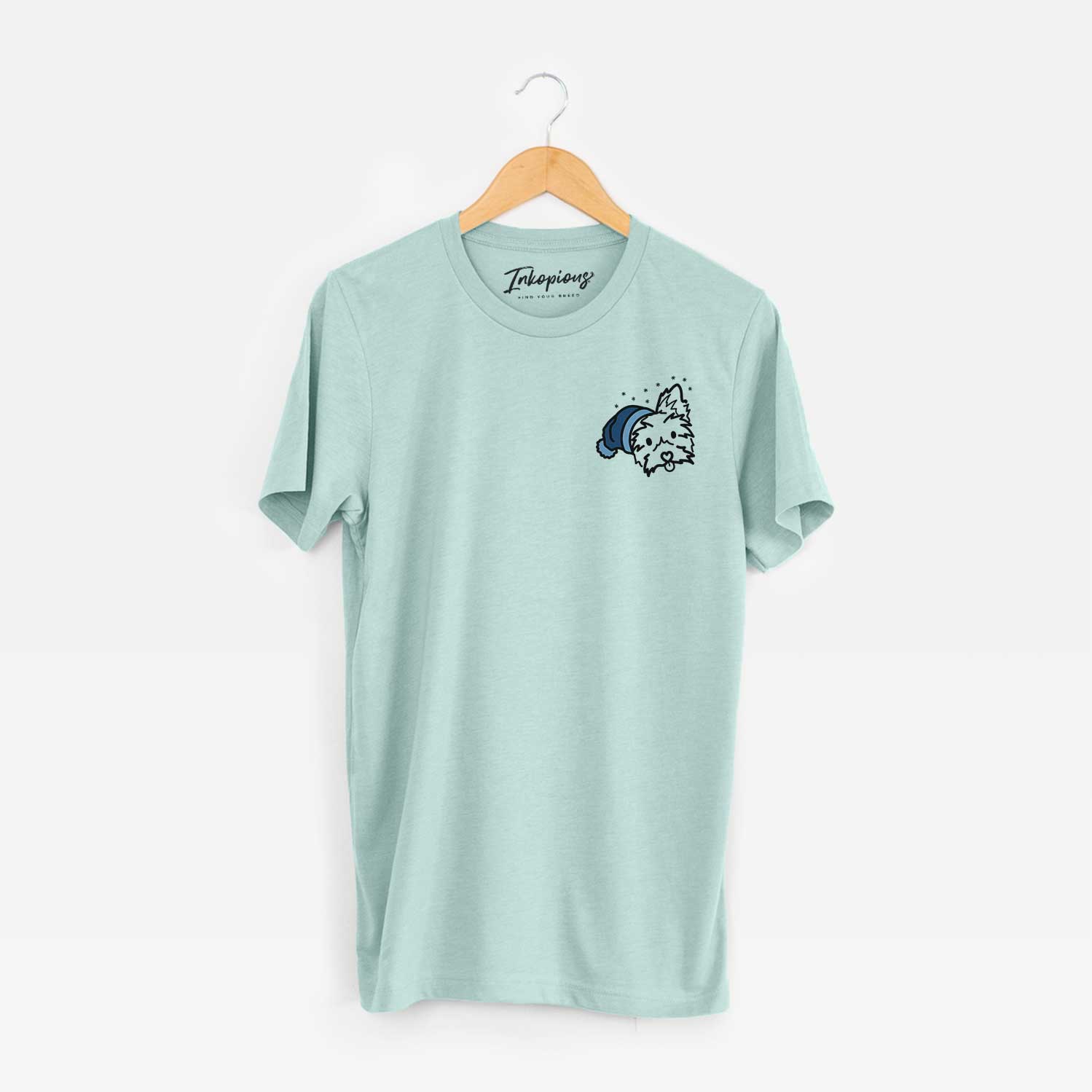 Small chest-pocket minimalist line drawing of Luna the Yorkshire Terrier wearing a winter beanie on a Heather Sage Unisex crewneck