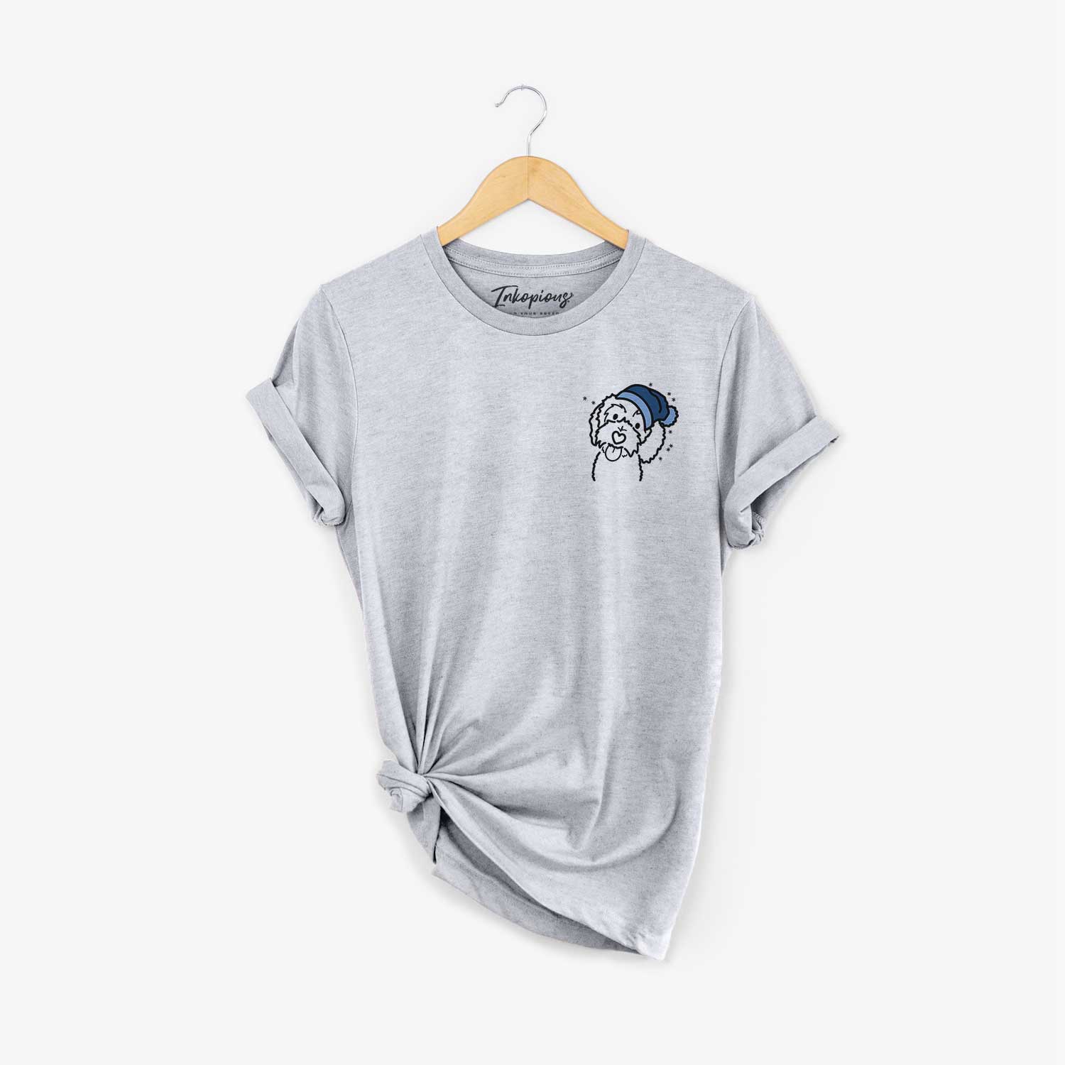 Small chest-pocket minimalist line drawing of Mabel the Bernedoodle wearing a winter beanie on a Grey Unisex crewneck