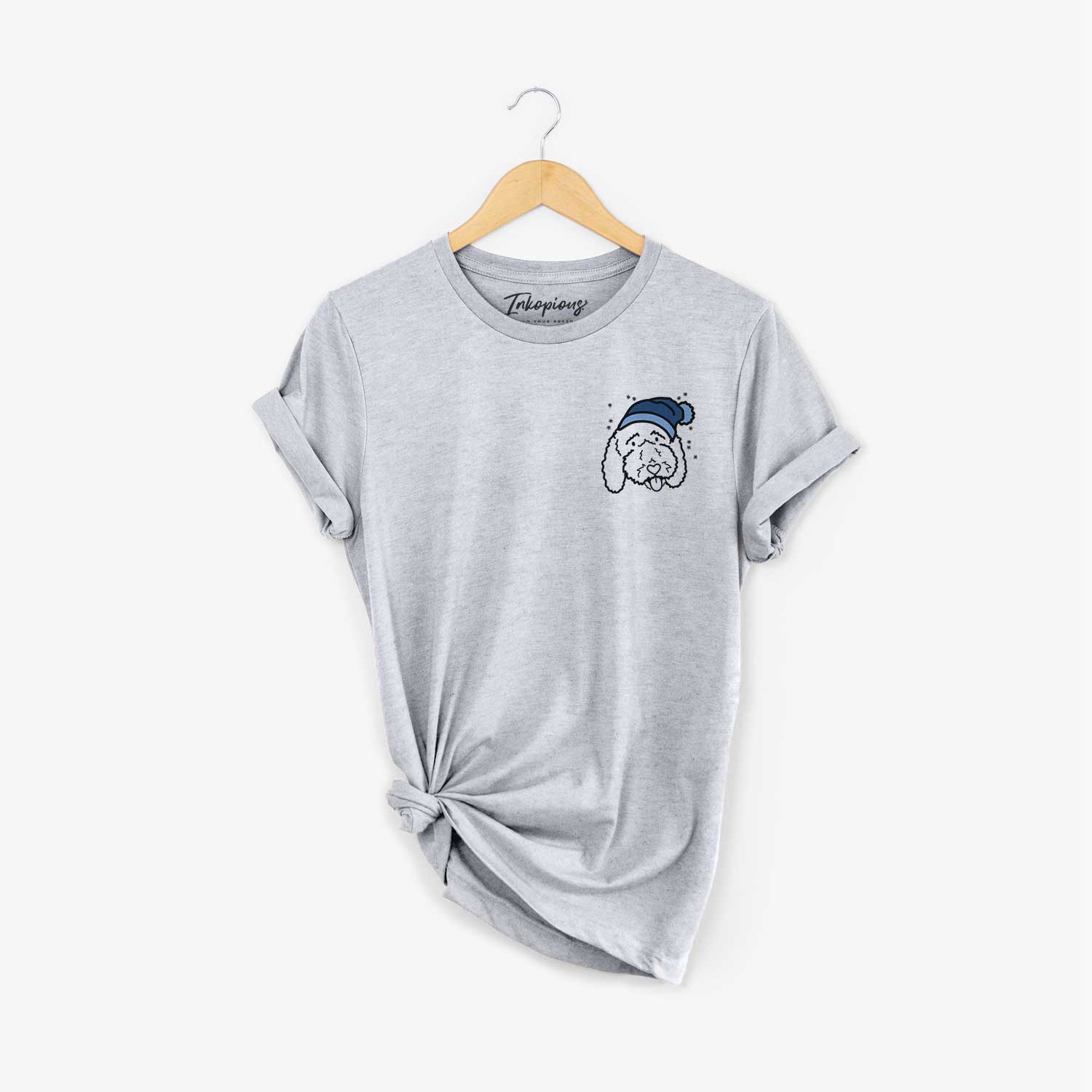 Small chest-pocket minimalist line drawing of Ruby the Bernedoodle wearing a winter beanie on a Grey Unisex crewneck