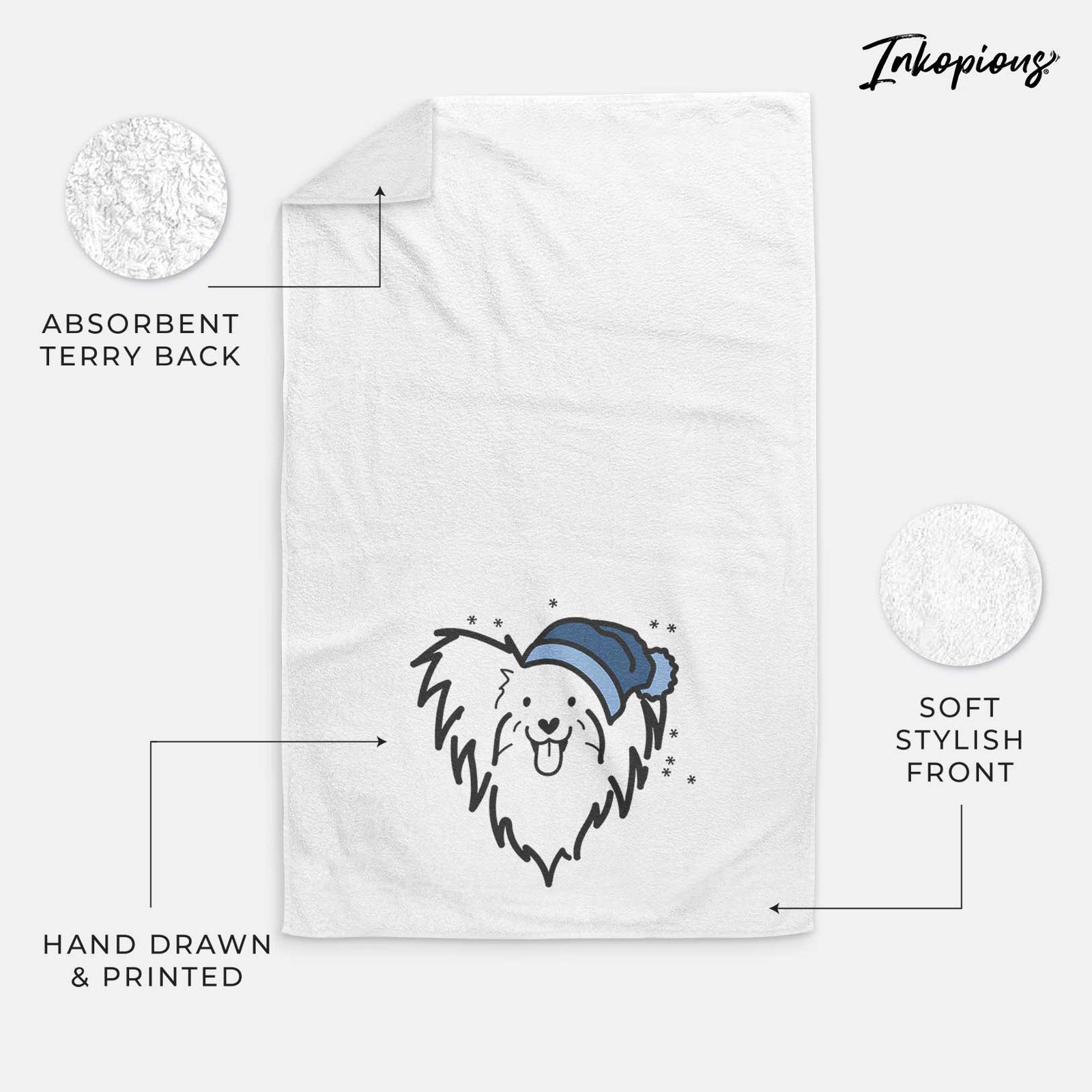 Minimalist line drawing of a Papillon wearing a winter beanie on a decorative hand towel