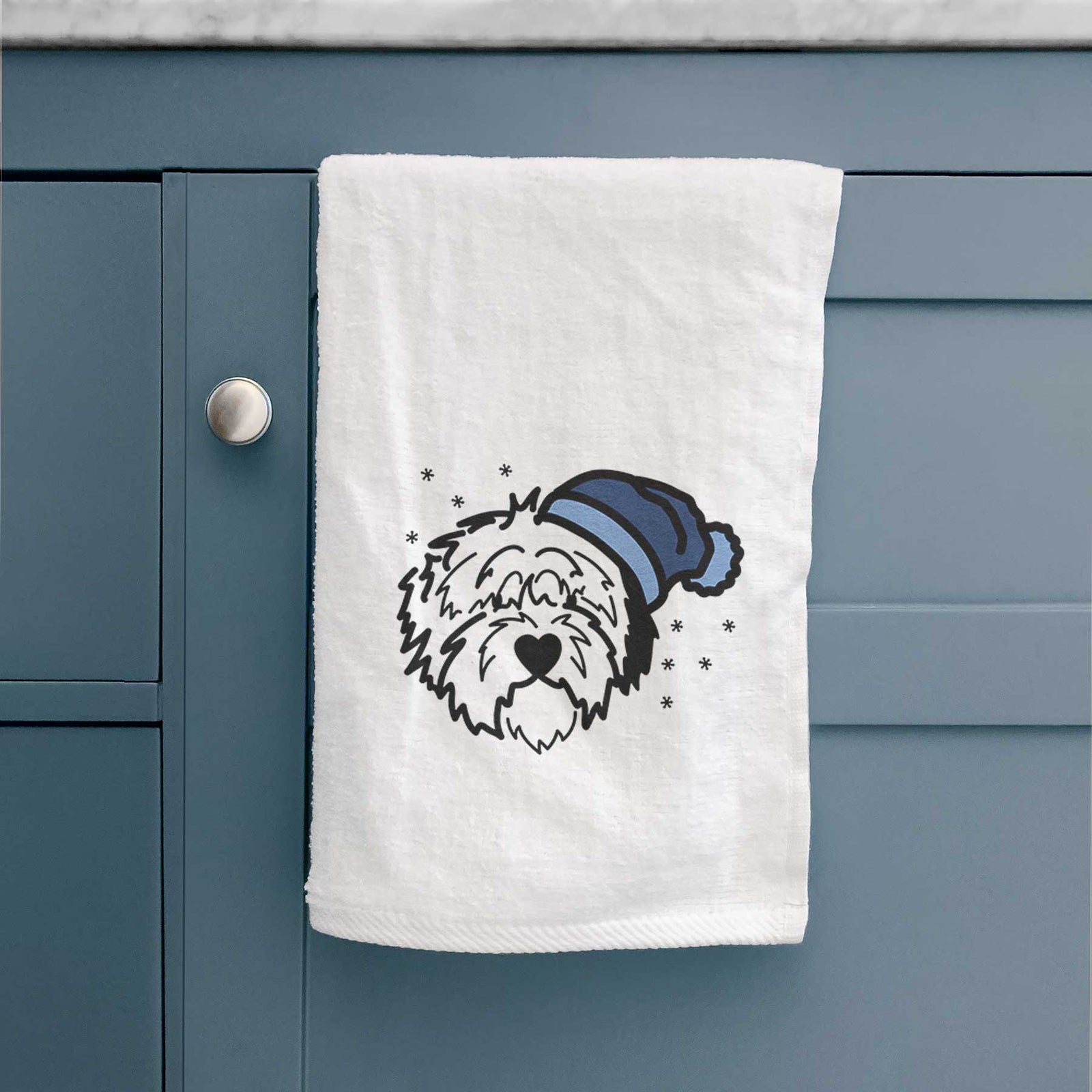 Minimalist line drawing of Penny the Old English Sheepdog wearing a winter beanie on a decorative hand towel