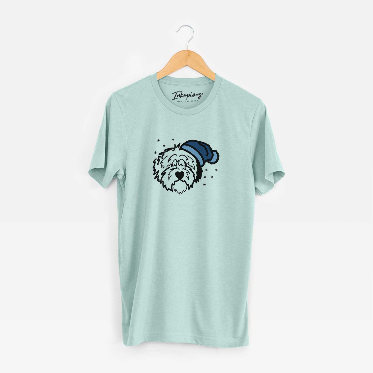 Minimalist line drawing of Penny the Old English Sheepdog wearing a winter beanie on a Heather Sage Unisex crewneck