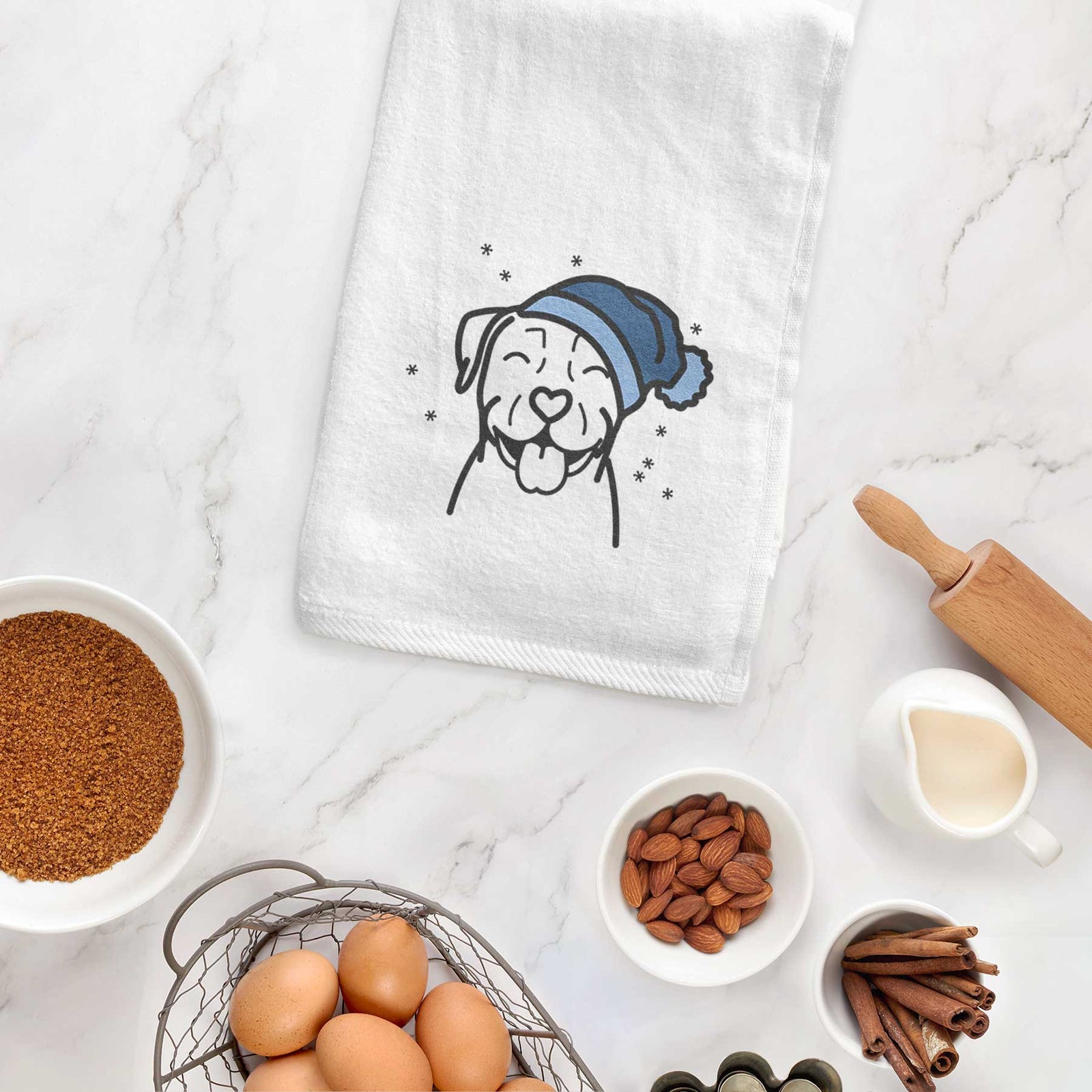 Minimalist line drawing of a Pitbull wearing a winter beanie on a decorative hand towel