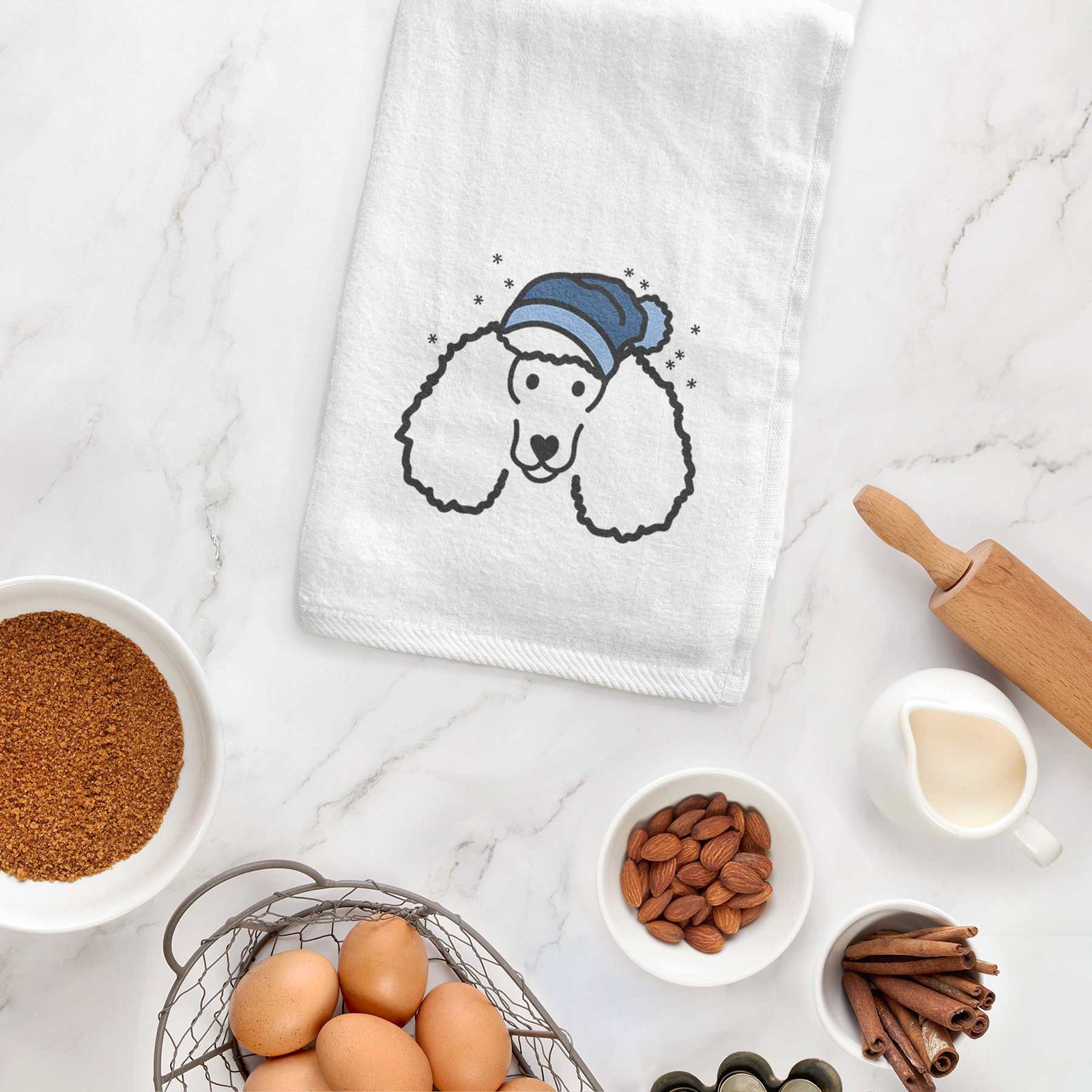 Minimalist line drawing of a Poodle wearing a winter beanie on a decorative hand towel