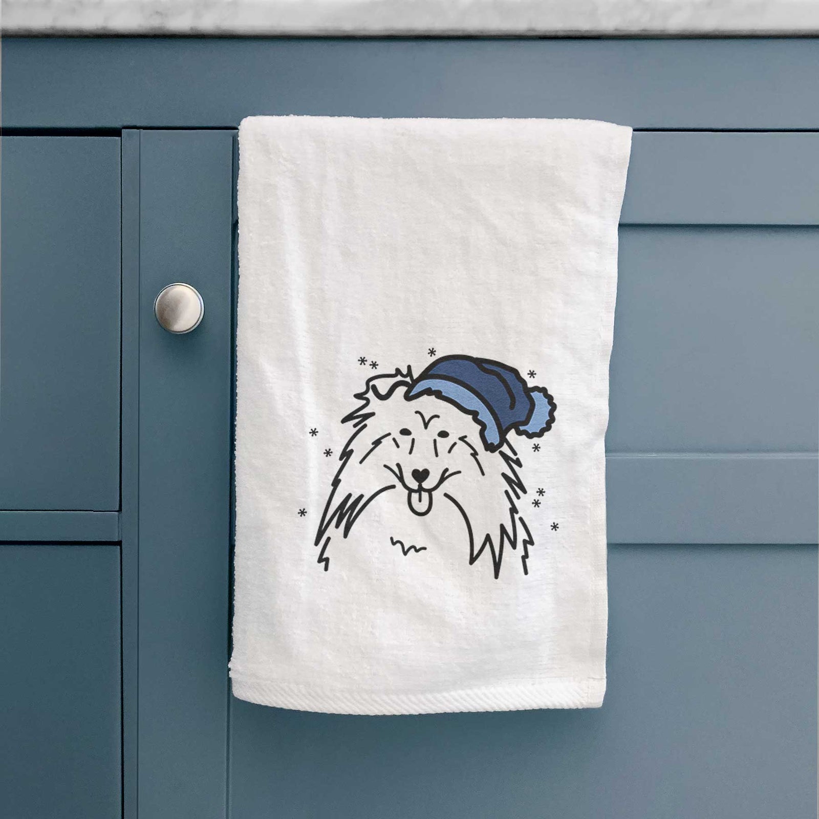 Minimalist line drawing of a Rough Collie wearing a winter beanie on a decorative hand towel
