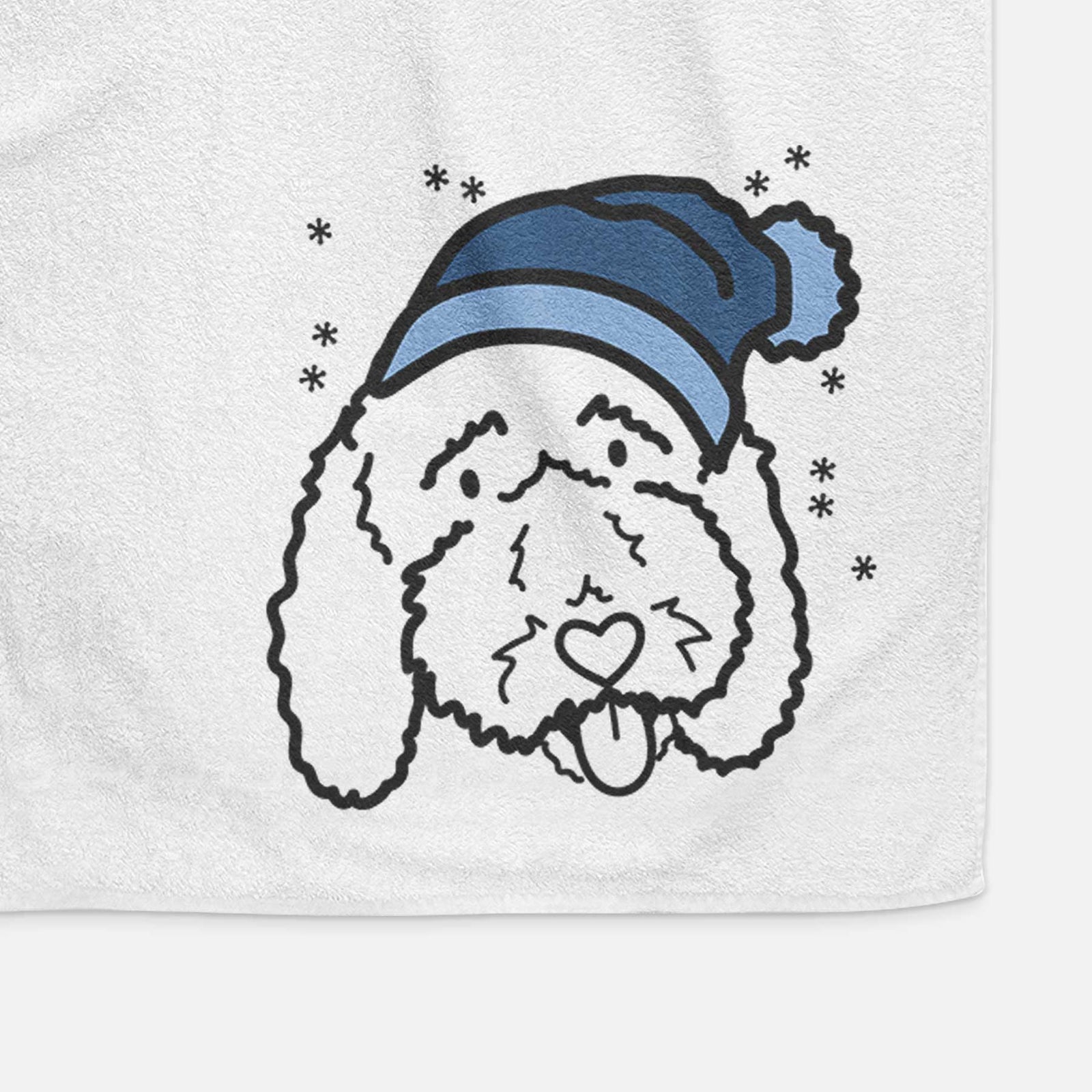 Minimalist line drawing of Ruby the Bernedoodle wearing a winter beanie on a decorative hand towel